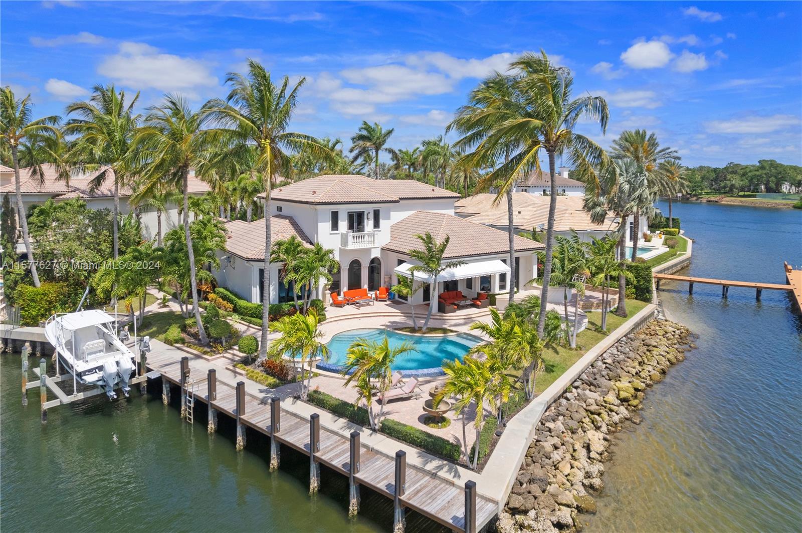 Beautiful waterfront property on a point lot with 260' of frontage and deep water dockage for up to an 80' vessel (special exception for 100' TBD) nestled in the prestigious gated waterfront community Harbour Isles. Panoramic views of the Intercoastal Waterway and North Palm Beach Country Club golf course. This 5 bedroom home includes a ground floor master suite, 1st floor, office, large open kitchen with a gas cooktop, wine cooler, center island and breakfast bar surrounded by a summer kitchen. Spacious outdoor patio includes bar, and BBQ. Dock includes boat and jet ski lift.. Great for the seasonal boat parade! Only minutes to Palm Beach Airport, gourmet markets, restaurants and all the amenities that make this part of Florida the place for a high quality, yet casual lifestyle.