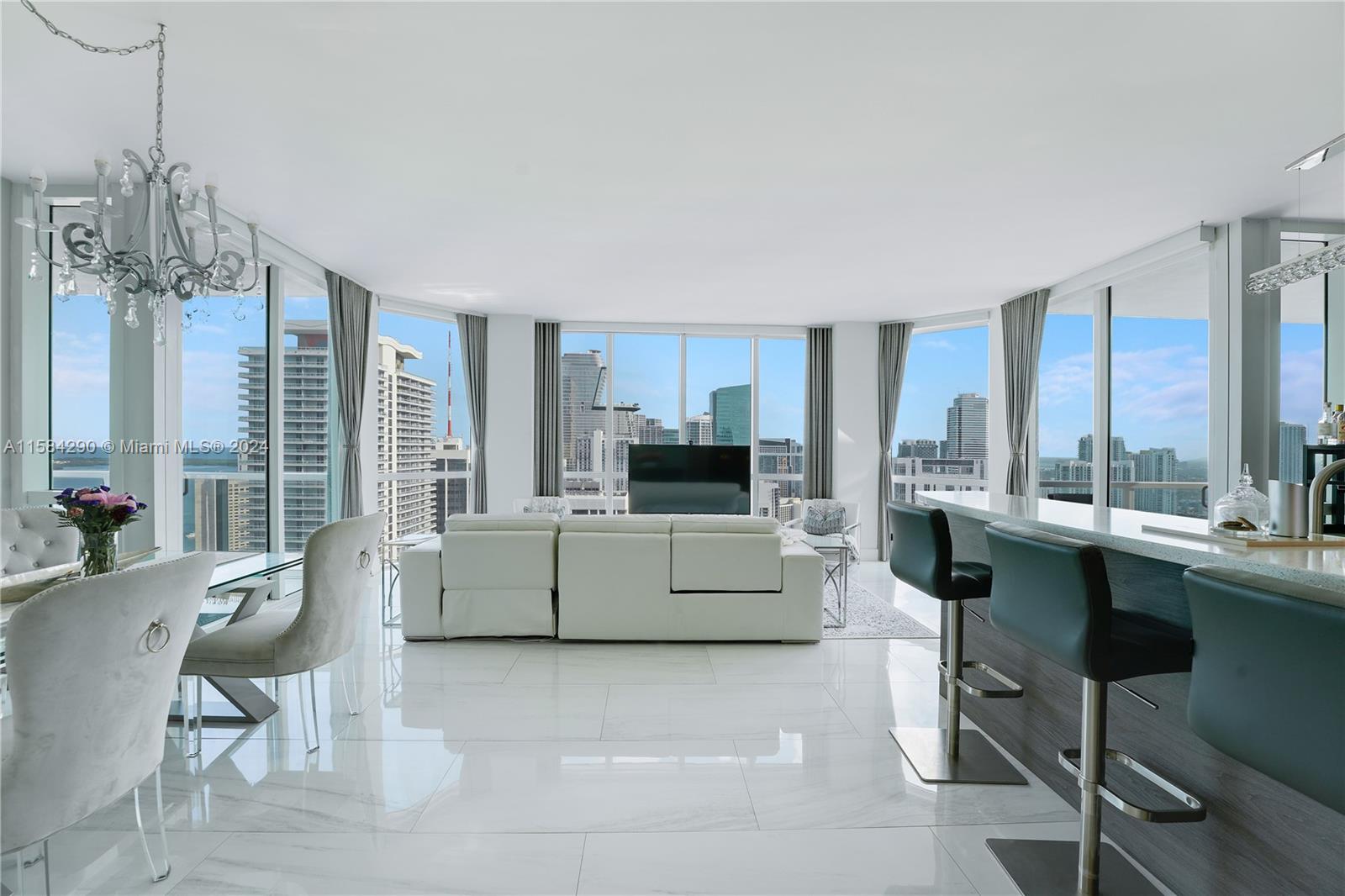 Experience the epitome of urban luxury in this exquisite 3-bed, 3-bath condo located in the heart of Miami's epicenter. Enjoy breathtaking skyline views through floor-to-ceiling windows. Indulge your culinary skills in the modern kitchen W/quartz countertops & top-of-the-line appliances. Entertain guests in the gorgeous modern living space W/180 degree water & city views. Retreat to your primary suite W/a lavish spa-like bathroom & walk-in closet. Exclusive amenities include 4 pools, security, private storage, gym W/daily classes, spa & 24-hr security. Don't miss your chance to own this urban gem, perfectly situated in the city's hottest neighborhood. Enjoy bayfront park or walk to Miami World Center to enjoy endless dining, shopping & entertainment options. Live the Miami dream today!