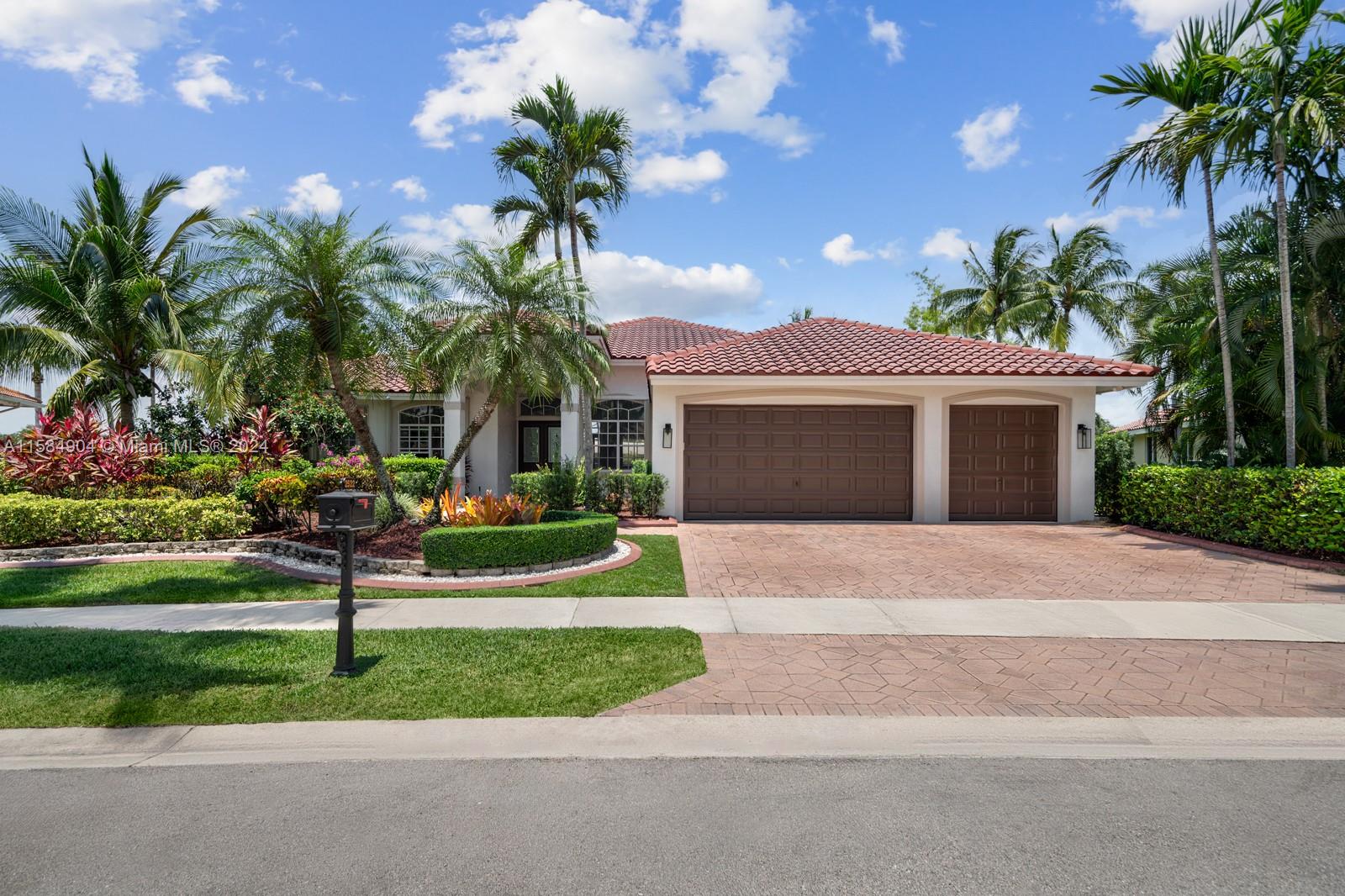 This beautifully renovated lakefront home in Weston Hills offers stunning golf views. With 5 bedrooms, 4.5 bathrooms, an office, and a 3-car garage. Situated on a meticulously landscaped 16,240 sq ft lot, this home showcases vaulted ceilings, new porcelain tiles, and elegant wood flooring. The updated kitchen features quartz countertops, double ovens, a Sub-Zero fridge, a Bosh dishwasher, and a Ruvati stainless sink. The primary suite is a luxurious retreat with a sitting area and walk-in closets. The en suite bathroom boasts a new vessel tub, quartz counters, a rain shower, and chic lighting. All bathrooms have been refreshed with a modern design. Outside, enjoy the screened-in lanai and al fresco patio. This sought-after home offers an exceptional living experience in a prime location.