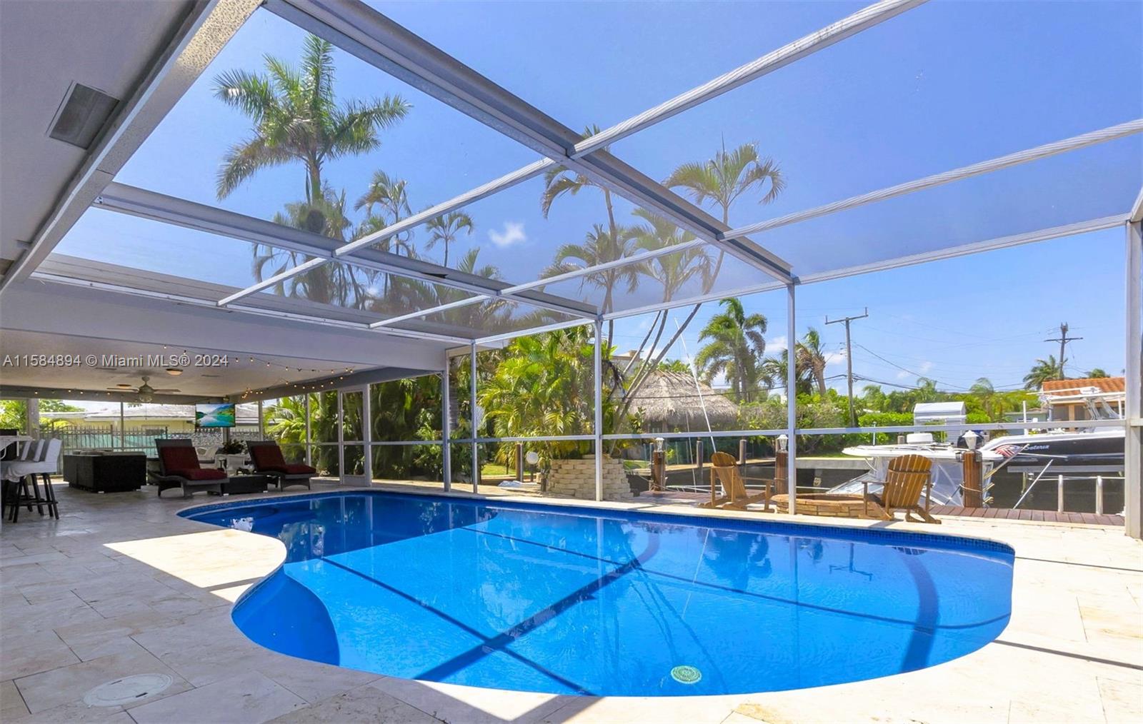 South Florida living at its finest with this stunning 3 bed 3 bath pool homel with 75' dock and direct ocean access(no fixed bridges). On an oversized lot this one of a kind home features a 20x60 enclosed lanai and a remote heated and salt system/screened in pool just steps away from your boat on the water. Perfect for entertaining and the ultimate in indoor/outdoor living, it also features luxurious travertine pavers, bistro lighting, wood burning fire pit, hot tub, heated outdoor shower, impact windows and doors, circular pavered driveway, air conditioned oversized garage and a whole house generator. Dock has water and electric(110 and 220) and wave runner lift. Great neighbors and walking distance to 4 restaurants, church and grocery store 1/4 mile away.