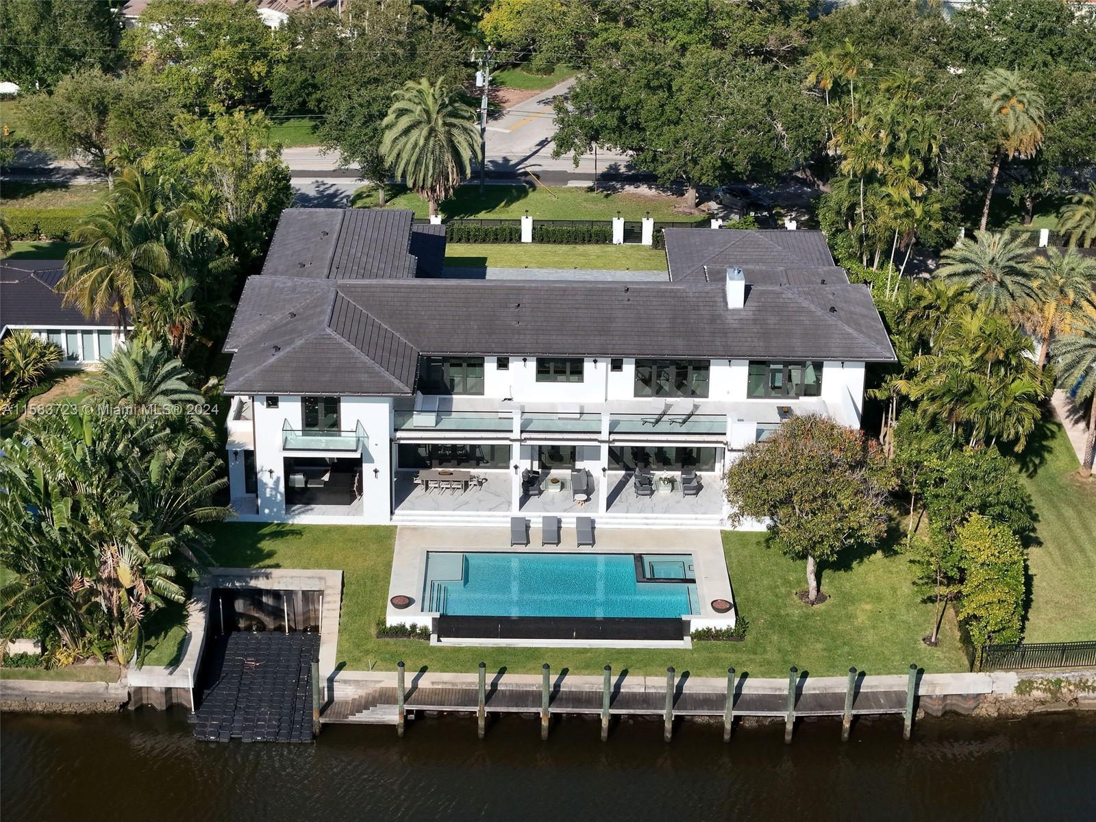 Elegant new construction on Coral Gables Waterway! This custom-built, gated estate abounds with luxury details and craftsmanship throughout. Featuring an expansive backyard replete with large covered terrace, infinity-edge pool, spa, boat cut-out & decadent summer kitchen. A wing is dedicated to entertainment: game room, office, theatre & wet bar adjoining an upscale cozy formal living room w/gas fireplace.  The graceful master suite has large dual closets, opulent bathroom, and a walk-in safe room. Upstairs bedrooms access walk-out balcony overlooking the tranquil waterway, homework stations, an arts/crafts nook, a second laundry room, and a wet bar with refrigerator.  Two staircases and elevator.  A full-house generator powered by city gas ensures safety and continuation of lifestyle.