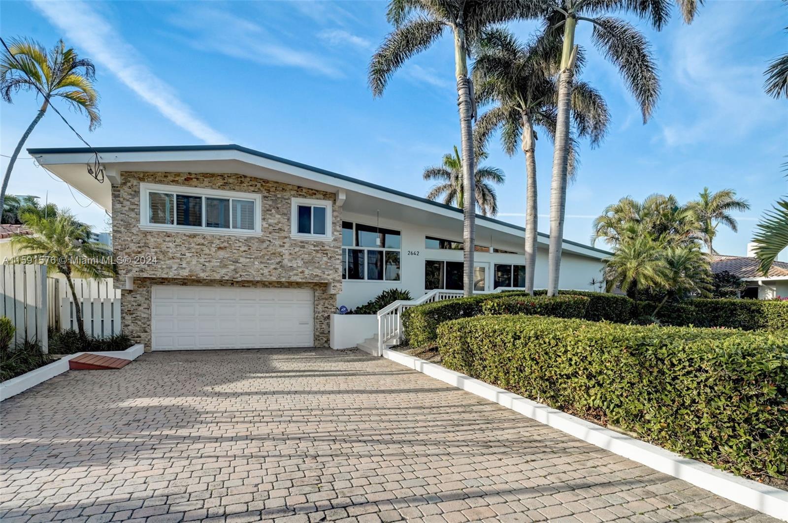 Newly updated Mid-century modern waterfront home in Fort Lauderdale Harbor Beach extension east of A1A!! Short walk to the beach,Optional HOA. 80' dock & boat lift! New updates include kitchen cabinets, quartz countertops, new flooring throughout, updated bathrooms, IMPACT WINDOWS & DOORS & NEW METAL ROOF! Live the life of fun,luxury and convenience in the most Exclusive part of Fort Lauderdale Beach