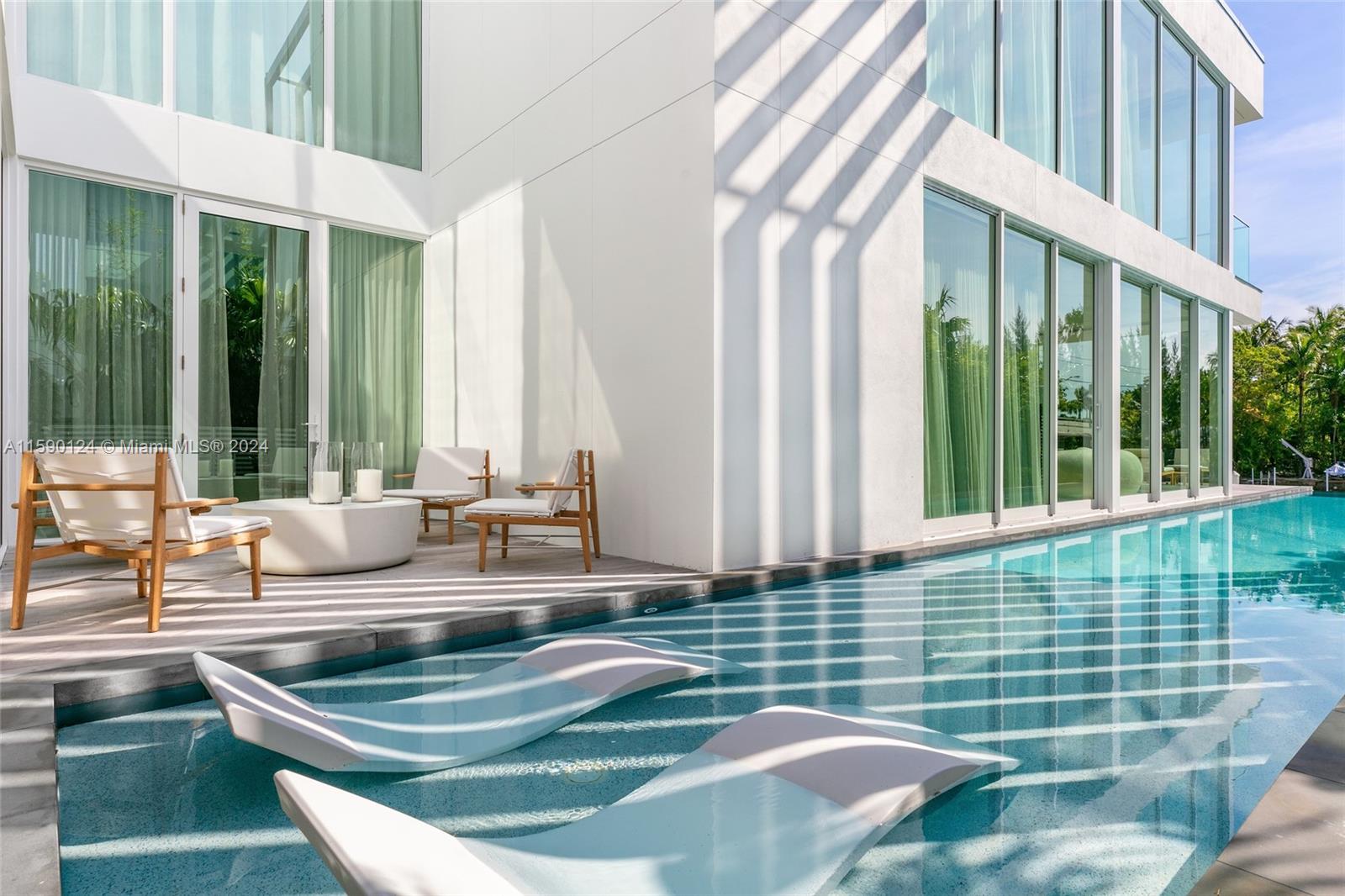 Experience the ultimate waterfront luxury at the Ritz Carlton Residences in Miami Beach. This exclusive two-story villa, crafted by the renowned Piero Lissoni, seamlessly combines the allure of a luxury hotel with the charm of modern tropical living. Its contemporary design features Georgette Select Limestone floors, wood floors, Boffi cabinetry, Gaggenau appliances, Ipe hardwood decking, Fantini faucets, and a gas generator. Nestled alongside Surprise Lake and offering access from your private dock to Biscayne Bay, the Intracoastal Waterway, and the Atlantic Ocean, this residence presents an ideal retreat that harmonizes the best of both worlds, the privacy and independence of your sanctuary while relishing in the world-class amenities and impeccable services provided by The Ritz-Carlton.