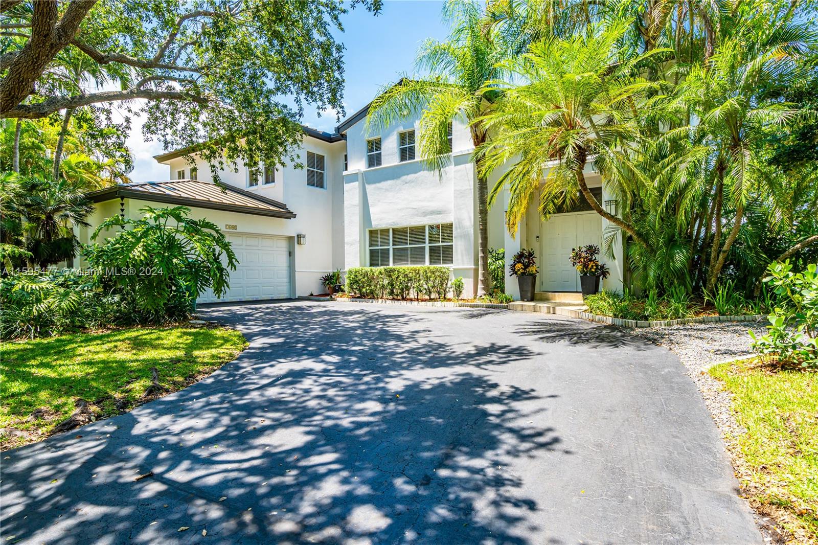 Rarely available in the GATED community of Old Cutler Cove, next door to Coral Reef Park in North Palmetto Bay, this charming 5 bed/3 bath home offers a great floor plan. The inviting formal living room with volume ceilings flows into the open, spacious kitchen and family room, showcasing views of the serene canal, manicured groundS and the custom pool and patio area which are ideal for entertaining. The ground floor features an in-law suite/guest room with a separate entrance and an additional den/office. Upstairs, is the primary suite with a private balcony and three additional bedrooms. Recent upgrades include a new metal roof in 2022, updated bathrooms, fresh paint inside and out, new appliances, and backyard pavers. Close to top-rated schools, parks, shopping, and more.