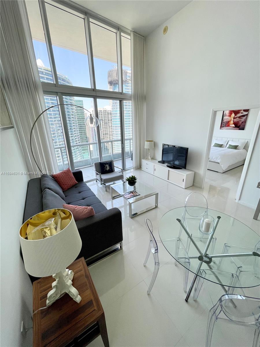 NO SUBLEASING, NO AIRBNB. Unique combination: High Ceiling and stunning view - only 2 in the entire building!  Fully furnished and beautifully decorated unit. Enjoy the views of Brickell, Miami River, and Downtown Skyline from your balcony. This spacious, high ceiling, modern unit features 24X24 Ceramic floors, walk in closet, travertine counters and stainless-steel appliances. Exclusive Resort Style building and top of the line amenities! Water, internet, and basic cable are included in the rent. Amenities include a 5-star SPA, largest infinity pool in Miami, great fitness center, free yoga, Pilates, and spinning classes, 24-hour Concierge and 1 valet parking.