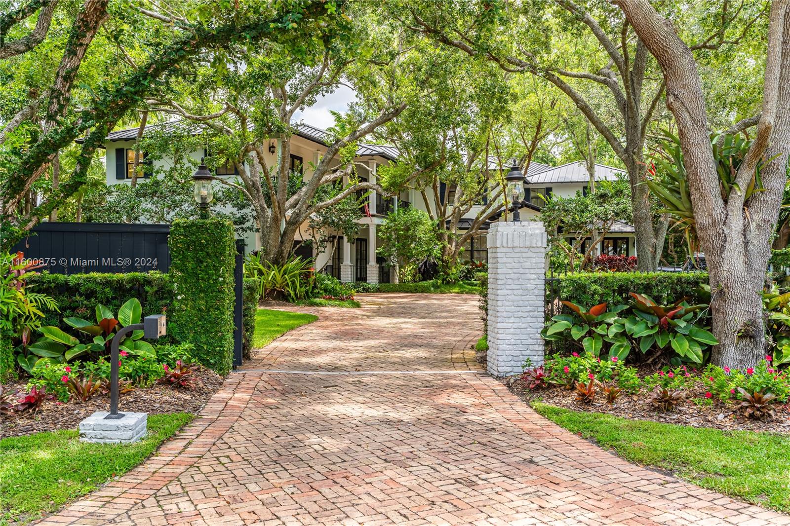 Located on a tranquil, tree-lined street in Pinecrest, this impressive gated home features 8 bedrooms and 6 bathrooms on a 40,336 square foot lot. The welcoming entry leads to a spacious 10,694 square foot interior with soaring ceilings. The eat-in kitchen, with top-of-the-line appliances and a large island, flows into the family room. The formal dining room includes a custom temperature-controlled 2,000-bottle wine cellar. The primary bedroom offers walk-in closets and a private balcony with stunning backyard views.
Outdoor amenities include a pool, outdoor kitchen, gazebo , basketball court, and putting green. Other Highlights  are metal roof, guest quarters, a generator, and a 2-car garage. Don't miss out on this amazing property.