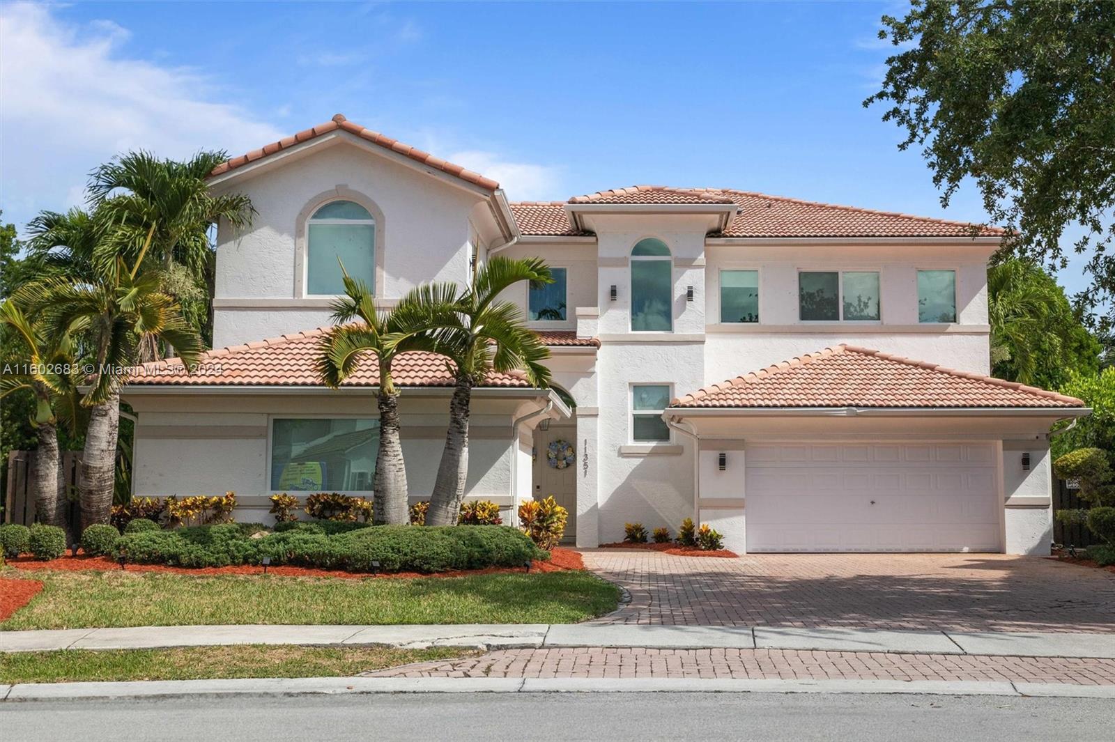 Luxury home in Doral Isles, 3,684 square feet that combines elegance and functionality. 6 bedrooms, including a maid's room, and 4.5 bathrooms, offering comfort and space for the entire family. The ground floor boasts a grand family room and a dining area, creating a perfect space for entertaining and daily living. The kitchen is a showstopper, modern and equipped with top-quality finishes and high-end appliances. Hurricane-resistant windows, Luxurious light fixtures will remain in the property. The master suite includes a large sitting area, extensive closets, and ample storage. The expansive backyard includes a heated saltwater pool and a jacuzzi.  The garage accommodates two vehicles, with outdoor space for four additional vehicles, ensuring ample parking for guests and family alike.