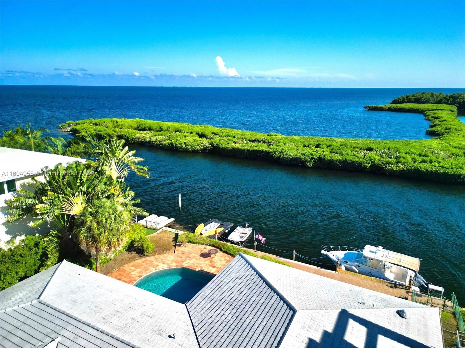 Rarely available direct Bayfront property offered at an incredibly modest price!  This pristine and spacious sun-filled 4 bedroom mid-century modern style home has an open floor plan. The great room, kitchen and bedrooms all have expansive windows with gorgeous water views.  Located in the sought after Coral Gables guard gated community known as "Gables by the Sea" this property is sure to exceed your expectations. Enjoy as it is now, or build the home of your dreams on this spectacular Biscayne Bay/Atlantic Ocean property, affording spectacular, endless open water seaside views from sunrise to sunset, a must see!