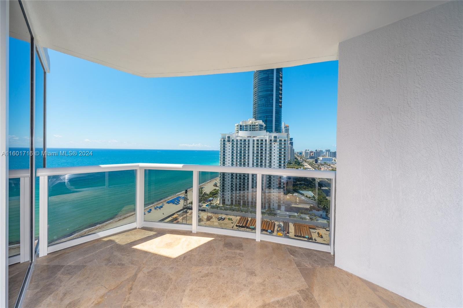 This magnificent 3 bed. 3 1/2 bath. SE corner residence offers one of the best layouts paired with the most amazing panoramic view in South Florida, overlooking the ocean, bay and city of Sunny Isles. The unit features three bedrooms in-suite with a powder room accessible by private elevator. Many upgrades, including marble flooring throughout, custom made high end built-ins with exotic wood, elegant Murano glass light fixtures, electric screens and more. Property offers lots of amenities including: recently renovated pool deck area w/swimming pool, hot tub, spa, tennis courts, restaurant, community room and roof top deck. Services included: Beach service, 24-hour security, full concierge and valet. Walking distance to shopping, restaurants, K-8 school and house of worship.