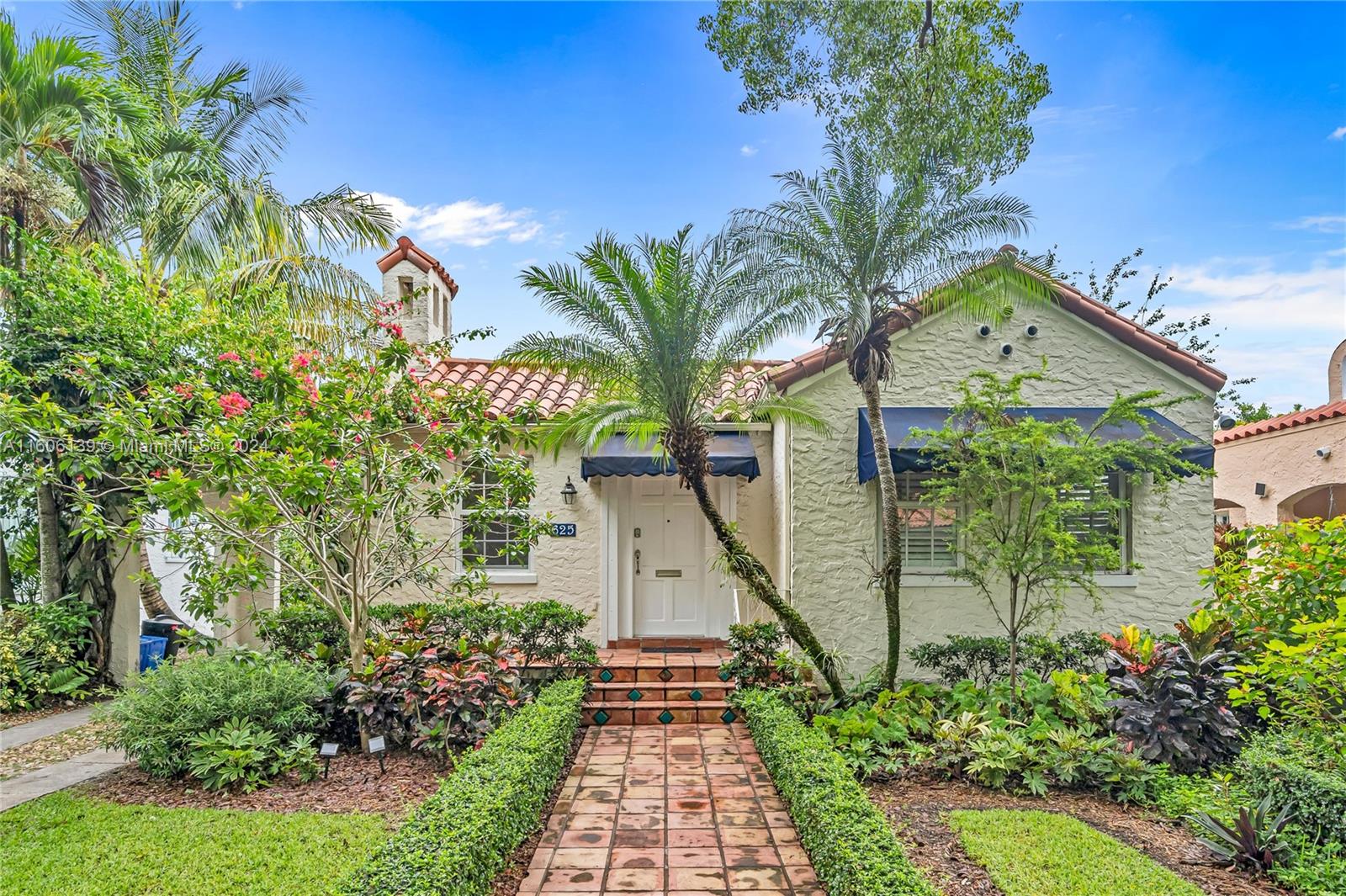 Welcome to this quintessential 1925 Old Spanish gem nestled on a tree-lined street in Coral Gables. This beautiful home seamlessly blends timeless charm w/ modern updates. Full of character w/ an original fireplace, hardwood floors & abundant natural light. The main house offers 2 spacious bedrooms & 2 full baths. Detached 1/1 cottage serves as perfect home office or guest quarters. Enjoy a renovated kitchen w/ ample storage & breakfast nook. Primary suite w/ walk-in closet & large bathroom. Tropical backyard oasis w/ deck, private patio & lush landscaping, ideal for relaxation & entertaining. Upgrades include impact windows, recessed lighting & new water heater. A carport ensures convenient parking. Ideal location just 2 blocks from Granada Golf Course & walking distance to Miracle Mile.