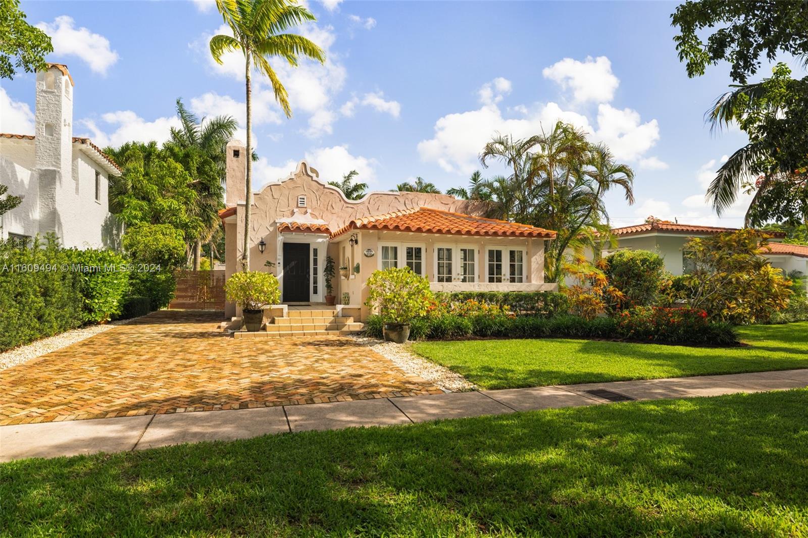 Designed by the renowned Walter C. DeGarmo, this charming Old Spanish home sits on a 7,500 sq. ft. lot on Obispo Ave. The residence features three bedrooms and two bathrooms, with preserved archways and a functional fireplace. The light-filled living and dining rooms enhance its historic charm. The 150 ft deep lot offers ample space for expansion or adding a pool. The backyard is a private tropical oasis with a classic tiled covered porch. The detached garage is perfect for a home office, yoga studio, or guest house. Conveniently located near golf courses, the Biltmore Hotel, top schools, and Merrick Park shopping. Enjoy a peaceful, shaded natural environment in both the front and back yards.