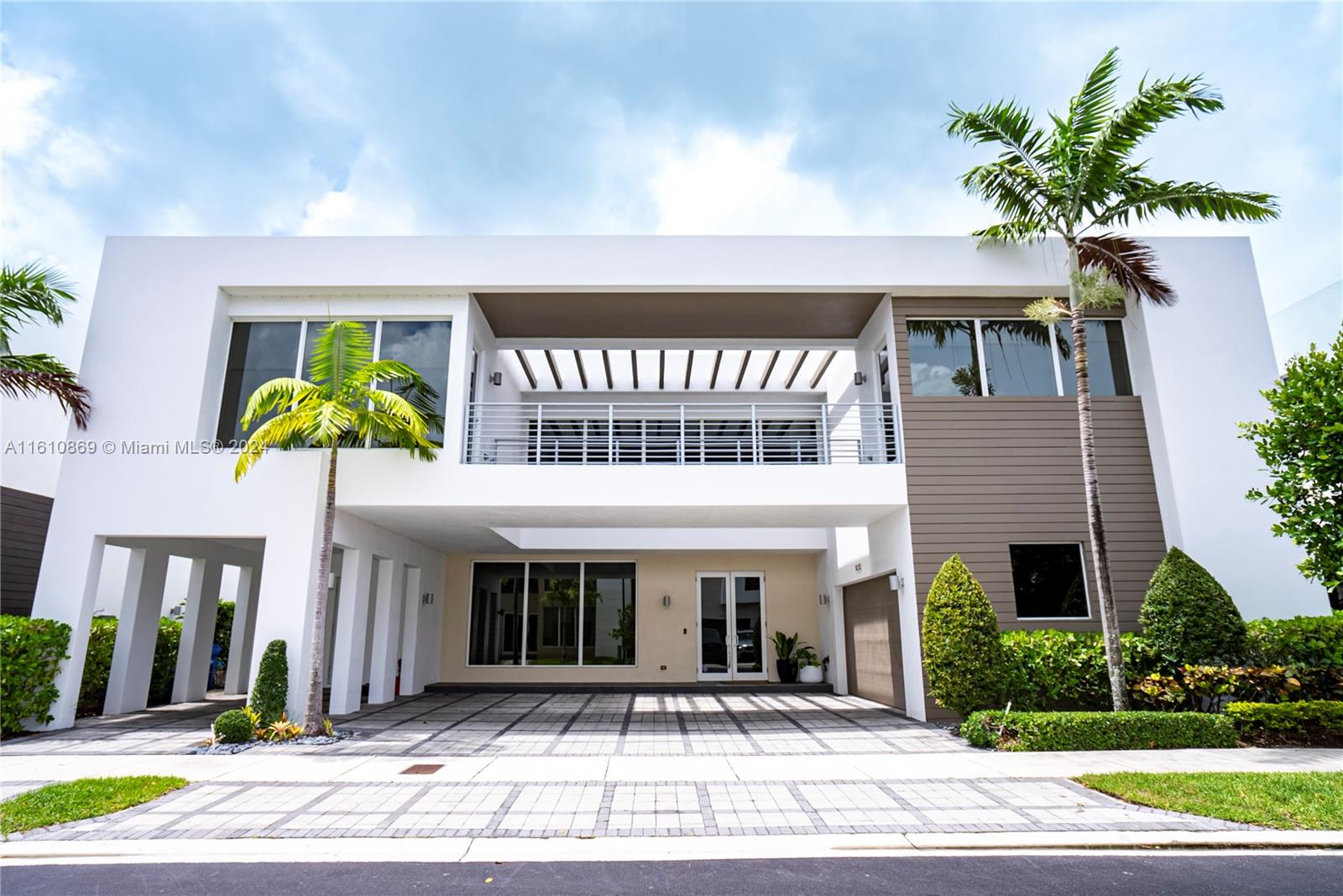 Stunning and impeccable home at the prestigious Modern Doral 75. This smart home has 6 bedrooms and 7 full bathrooms, marble and wood floors, high ceilings, impact windows, kitchen with top-of-the-line stainless steel appliances, glass and steel staircase railing, garage space for 2 cars and additional 5 parking spaces in the driveway. Great backyard waterfront to the lake with built-in BBQ, sink, and refrigerator. A significant highlight of this property is its solar panels, offering an autonomous energy source and resulting in considerable savings on electricity bills. Modern Doral is a full-service community, offering club house, fitness center, children's playground, pool, spa, gym, business community, media center and a children's room, gated community 24/7 security, MUST SEE IT!!