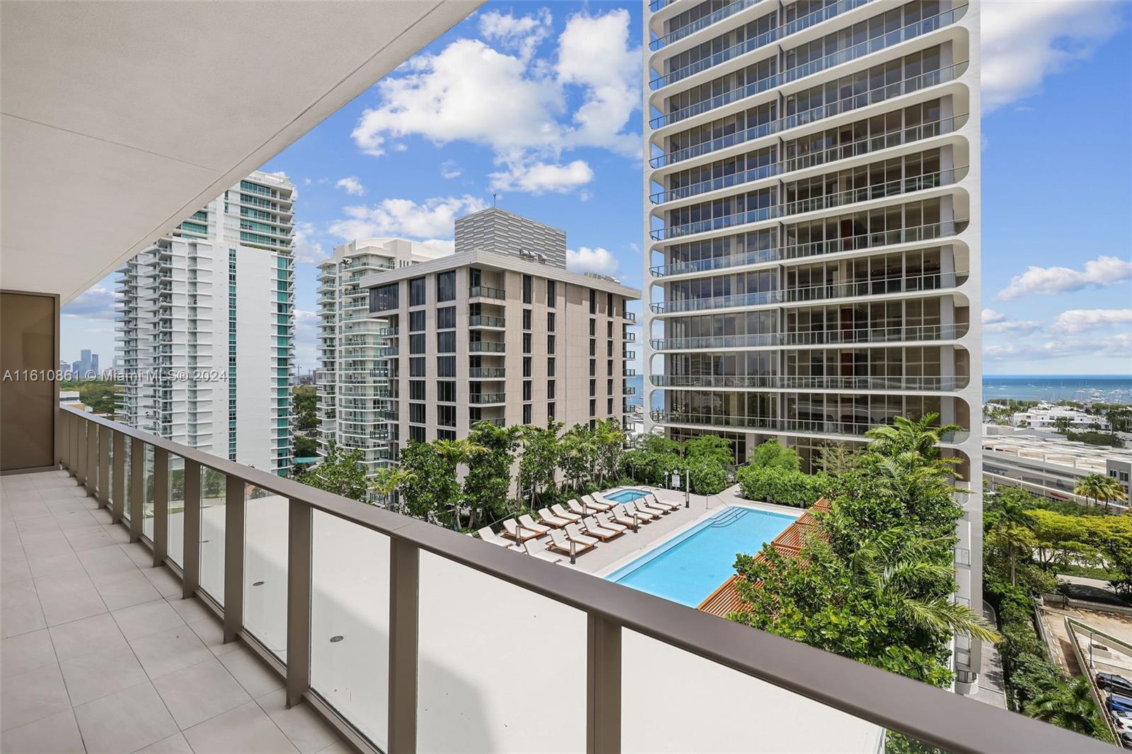 The 2 bedrooms and 2 1/2 bath wrap-around unit, 343 sq ft outdoor living, boast panoramic view of bay and Coral Gables.  It is a corner unit facing east and south.  The building includes 24 concierge, two pools with food and beverage services, gym, spa, an onsite restaurant, 24 hr valet for 2 parking, storage space (assigned to the unit) and more.  Unit has porcelain floor; an Italian modern kitchen designed by Italkraft,  with sub-zero appliances; Samsung washer/ dryer.  It has an assigned storage space with A\C.  Enjoy a lifestyle of walkability to all the Grove has to offer while living in a 5- star full serviced building.