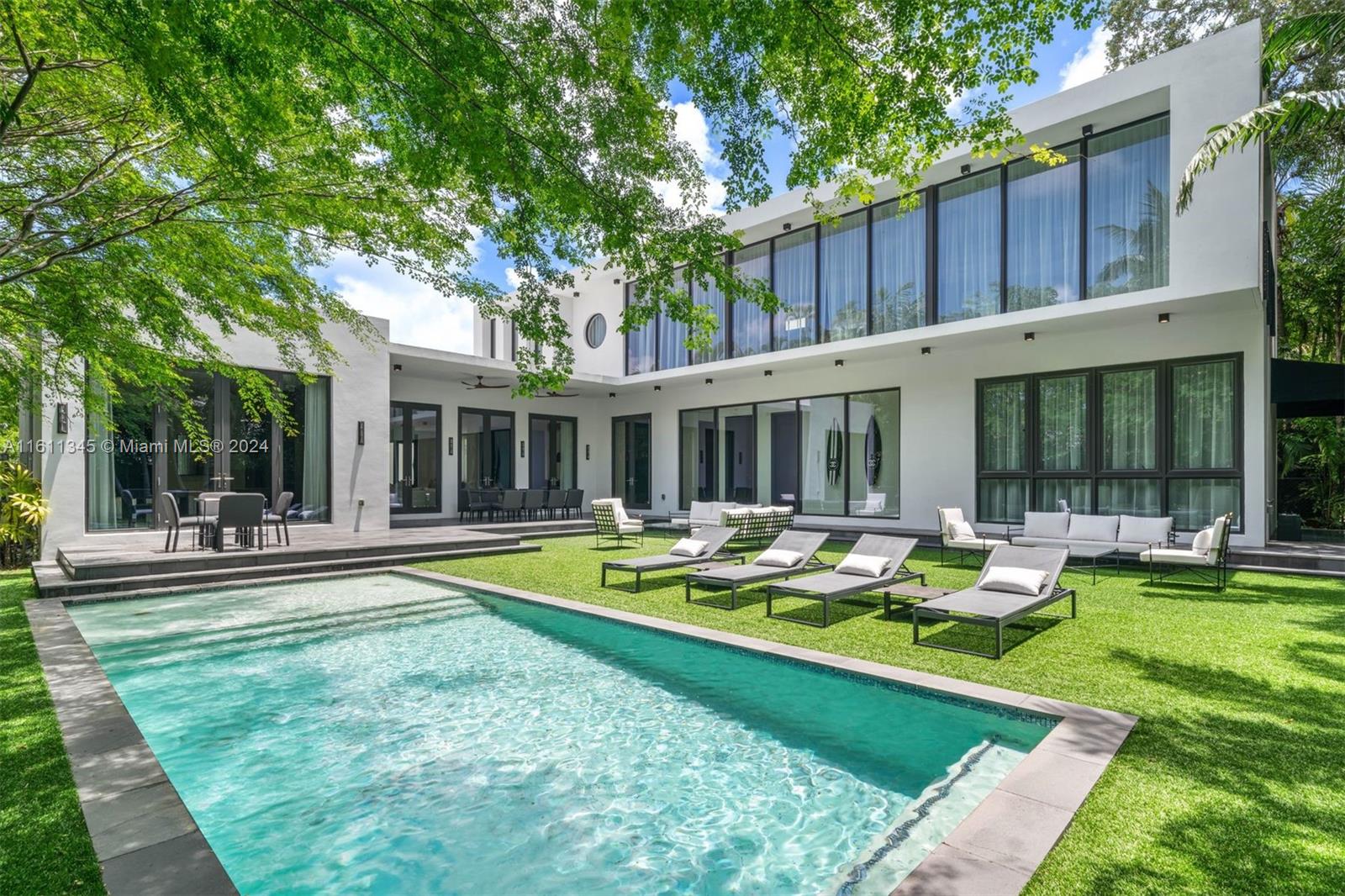 A contemporary gem situated in one of Miami's prime and exclusive neighborhoods. Upon entering, you are greeted by an airy, meticulously arranged living space featuring 10-foot ceilings. The well-crafted floor plan includes European plank oak floors and 9-foot Italian doors, seamlessly separating the 5 bedrooms and 4.5 bathrooms. A chef's dream kitchen, outfitted with a 60-inch Viking gas range and highlighted by a stunning exotic marble countertop, ideal for hosting family and friends. The second floor is dedicated to a grand 1,000-square-foot master suite, complete with a separate office space, his and hers closets, and an opulent master bath. The expansive yard is perfect for entertaining, featuring a pristine salt-water pool, making this home the epitome of luxurious living.