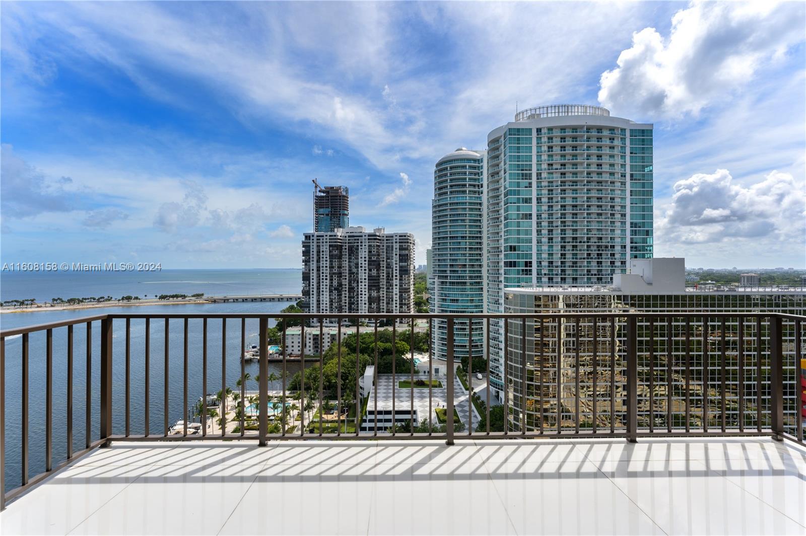 Originally 3 bedrooms converted to 2 bedrooms, which can be reconverted, this stunning TOP Floor 2-story Brickell Penthouse boasts 22' high ceilings and waterfront views. Enjoy panoramic ocean and city vistas, as well as breathtaking sunsets from every room. A striking custom stainless steel and mahogany circular staircase connects both levels, showcasing custom doors and meticulous details. The open island kitchen features top-of-the-line Thermador appliances. The master marble suite offers a Zen tub, double rain shower, and stunning bay views. Residents can indulge in amenities such as a private pool, cabanas, hot tub, children's pool and playground, 6 tennis, racquet, and basketball courts, state-of-the-art gym, party room, private marina, and BBQ area by the water's edge.