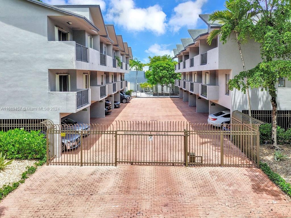 Discover luxury living in this exquisite two-story townhouse nestled in Coconut Grove. This corner unit has passed its 40-year re-certification inspection, ensuring quality and peace of mind. It features covered parking for two cars and boasts four balconies with garden views and abundant natural light. The spacious home offers two generously sized bedrooms, two-and-a-half bathrooms, and a backyard perfect for outdoor gatherings. Located near Coconut Grove’s shops and dining, Dinner Key Marina, Cocoa Walk Shops, AMC theaters, and restaurants, it blends tranquility with urban convenience. The condo association's reserves enhance property value and stability, offering a sophisticated lifestyle in a lush tropical setting.