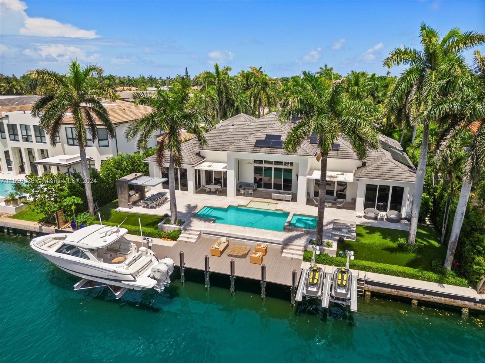 Welcome to your dream home in Golden Beach's exclusive South Island! This unique turnkey one-story residence, set on an oversized 18,975 sqft lot, features a spacious open floor plan with soaring 16 ft ceilings. Revel in stunning waterfront living with 115 ft on the water, complete with a newly built boat lift and a yacht and jet ski-equipped dock. The home boasts 6 luxurious suite bedrooms, including an oversized master suite with an outside Bali-style bathroom, a gym, and a second-floor in-law's or a teenager's dream unit . The manicured resort-like outdoor space is perfect for entertaining. Decorated to perfection and designed for the ultimate entertainer, this custom masterpiece offers unmatched amenities and is one of the most unique and desirable  properties in the neighborhood.