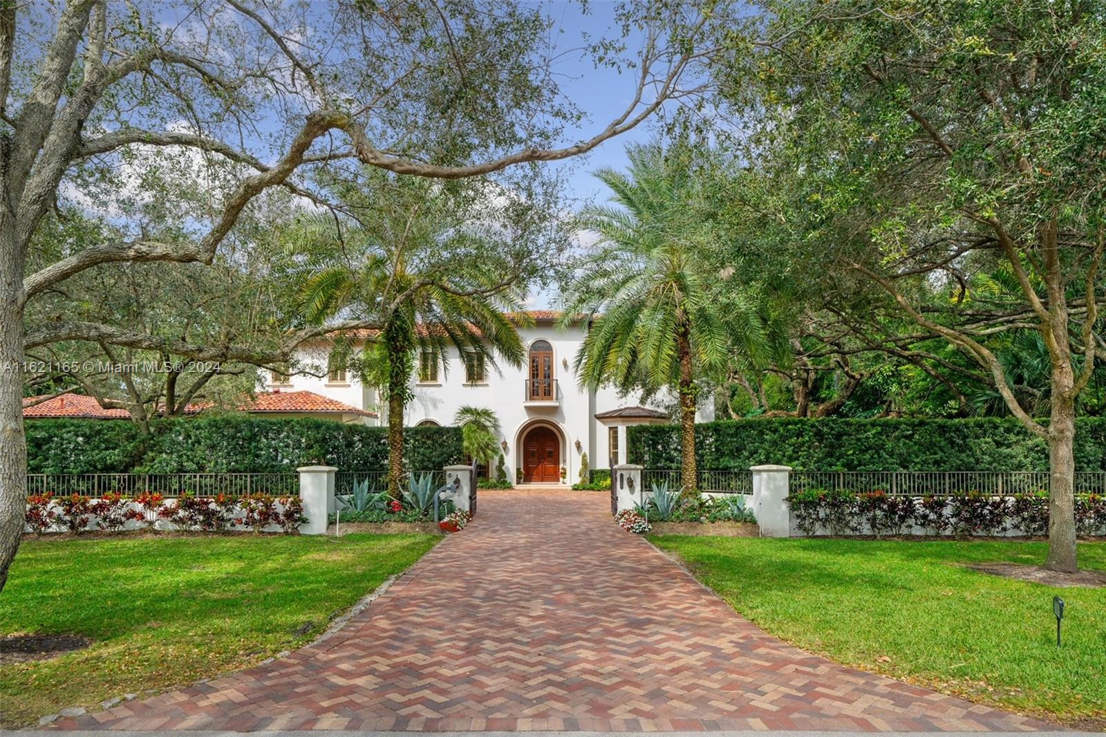 Nestled in North Pinecrest, this luxury estate crafted by Richard Stoker spans a 38,768 sqft lot. For a car enthusiast, it features an 8-car garage with 2 lifts, totaling 10 cars. This two-story residence includes 6 br & 7.5 bath. The grand foyer leads to formal living & dining rooms. Designed for entertainment, it offers a chef’s kitchen, butler’s pantry, laundry rooms, elevator, bar, wine cellar, playroom with wet bar, gym, & spacious dining & TV rooms. The master suite has a sitting area, office, terrace, walk-in closet, his and hers bathrooms, jacuzzi, & double shower. Outdoor living includes a patio, summer kitchen, grill, pizza oven, & refrigerators. Dining areas overlook the pool & spa. The estate has a generator with dual gas tanks. This unique home embodies luxury and convenience.