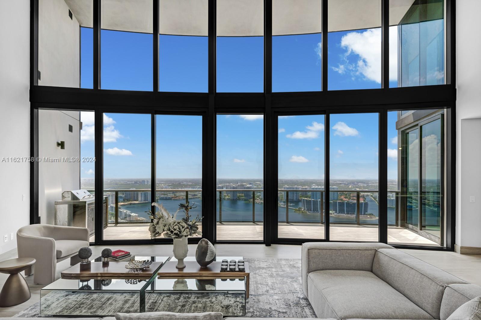 Discover luxury living in this 3-bed, 4.5-bath 3,100 sq ft apartment spanning 3,100 sq ft of sheer opulence. As you enter, you'll be greeted by soaring 21-foot ceilings adorned with floor-to-ceiling windows that offer breathtaking panoramic views of the sunset, downtown Miami, & the tranquil Intracoastal waterway. Indulge in the epitome of modern living with a sprawling balcony, providing ample space for al fresco dining or simply basking in the beauty of Miami's skyline. The sleek & contemporary design features a carbon fiber kitchen, perfect for culinary enthusiasts & entertainers alike. With a 2-car garage & Dezervator car elevator, convenience is key. Elevate your lifestyle with 5-star amenities including concierge service. Welcome home to unparalleled elegance & comfort.