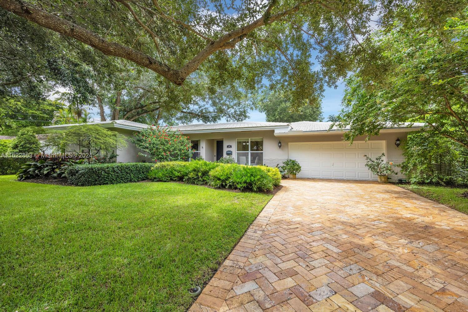 Nestled on one of the most unique streets in Coral Gables at the edge of Santa Maria St, this charming 3-bedroom, 3-bath home is a must see! This quintessential Gables home includes a bright living room and dining room, plus original oak hardwood floors. An upgraded kitchen is a haven for culinary entertainers with custom cabinetry, stainless appliances and a walk-in pantry. A separate family room with a wet bar overlooks the lush garden. The master suite was a later addition, and is complete with a charming fireplace, 2 walk-in closets and ample bathroom. A private garden oasis awaits, complete with a serene patio, an ideal retreat to enjoy gardening and entertaining. It also has a 2-car garage with ample storage! This home is nestled between the Biltmore Hotel and Riviera Country Club.