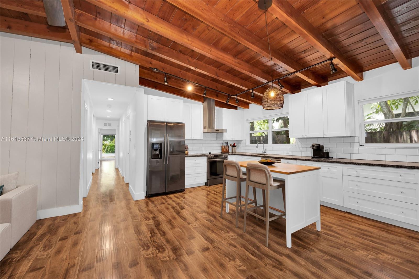 Endless opportunity and possibilities await with this renovated midcentury home on a fully gated corner lot in a prime location. Move right in, add on, or rebuild on the only 9,000+ sqft lot under $2.5M in all of Coconut Grove. The interior features impact windows/doors, vaulted wood beam ceilings throughout, renovated kitchen and bathrooms, luxury vinyl floors, fireplace, and laundry room. A screened front porch creates additional living space for friends and family to gather. Enjoy a lush yard, wood deck, and generous swimming pool. Create your dream home and live the Coconut Grove lifestyle with dining, shopping, and top public/private schools nearby. Some photos virtually staged.