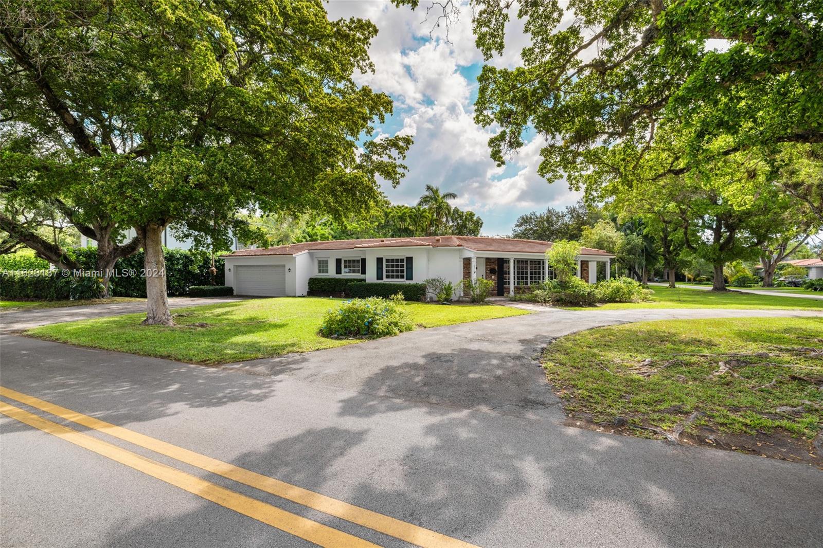 This beautifully updated 3-bedroom, 2.5-bath home, built in 1957, is a gem in the coveted Platinum Triangle of Coral Gables. It features unique architectural details and is perfectly situated on a corner lot. The home underwent major renovations in 2017, including updates to the septic system, all electrical work, the kitchen, bathrooms, half bath, laundry room, and sound system with high-quality cabling. The roof was replaced in 2019, and the AC venting system was updated in 2020. Modern amenities include a tankless water heater, green appliances, an electric car charger, and LED lights. The washer and refrigerator were added in 2022. Additional highlights include a screened pool and patio, hurricane shutters, an indoor laundry room, and a 2-car garage.