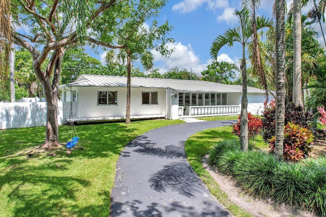 Nestled on a tree-lined street in the sought-after Mangowood community, this 4BD 3.5BA home offers nearly 3,100 sq ft of living space, including a play area, office, and den. Remodeled in 2020, it features updated PVC pipes, metal roof, smart home system, impact windows, resurfaced saltwater pool with heater, exterior uplighting, new electrical panel, and ductwork. Primary suite boasts a walk-in closet and exterior deck. The open-concept layout with a wet bar is ideal for entertaining. Enjoy rain showers, Toto toilets, an outdoor shower, 3 A/C units, and two tankless water heaters. Solar panels with a backup battery virtually eliminate the electric bill. Walk to Coral Reef Park/Elementary, and enjoy proximity to The Falls and Pinecrest's attractions. Seller covers $55k solar panel payoff.