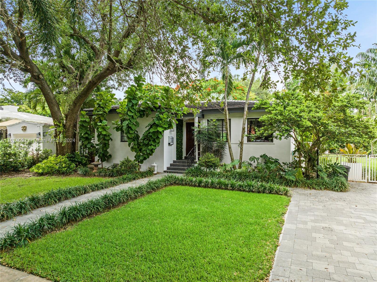 DOUBLE LOT IN CORAL GABLES. Perfect to move in, or do an addition and still have room for a pool. Newer ROOF, newer electrical and plumbing. Modern and upgraded, with lots of light and Hardwood floors. Open kitchen is modern with sleek cabinetry, modern bathrooms with showers.Some impact glass.Spacious living room/family room combination  and informal dining room but could be converted to a formal dining room. Large covered outside terrace perfect for outdoor living and enjoyment.Room for a large pool. Charming Coral Rock wall on the property and the property is completely fenced in.