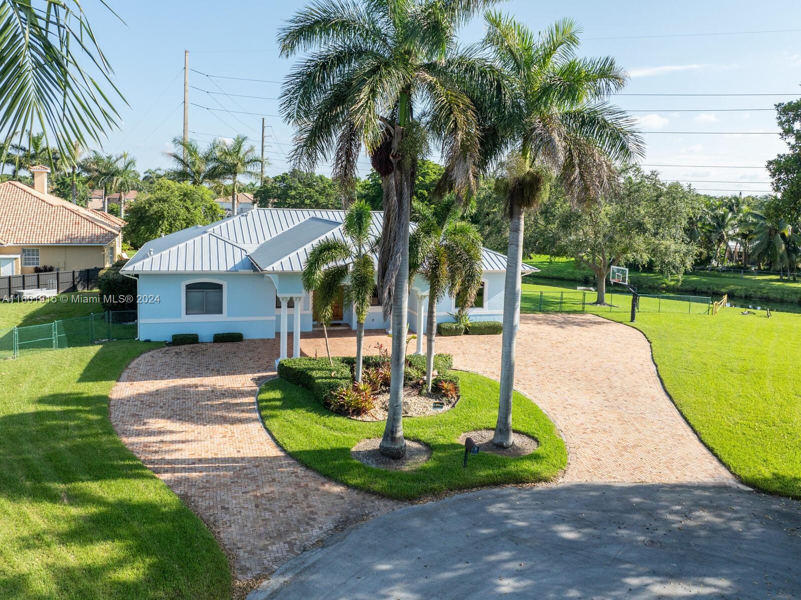 Experience tranquil Florida living in this serene Palmetto Bay enclave backing to a canal & cozy cul-de-sac.  A peaceful & spacious layout offering ideal spaces for relaxation, entertainment & privacy. Towering Palms trees at the entry round-about driveway. 5 beds 4 bath home has 11 foot ceilings & gorgeous travertine flooring. The kitchen is centered between the nook, family room, dining room & patio right around the corner. The primary suite has a 5-piece bath & bidet & separated private sinks & glassed shower entry with a whirlpool style soaking tub & 2 walk in closets. 2 more bedrooms with hall bath that exits to back patio. 1 more bed with en-suite bath & 1 private en-suite bedroom & full bath on the opposite side of the home.  Monstrous yard, impact windows & doors, 2 car side load.