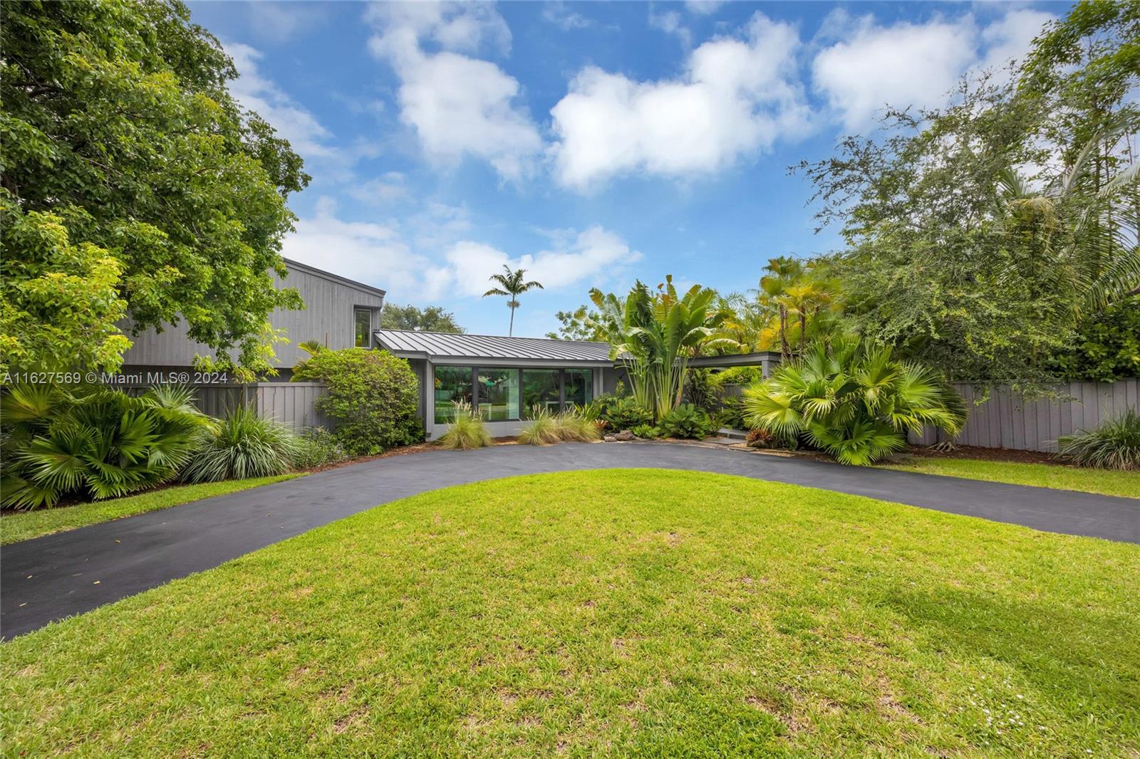 Tropical Paradise in Palmetto Bay! Embrace the South Florida lifestyle in this Spacious and Bright home, set on a lushly landscaped 33,997 SF lot. This home features 4 bedrooms, 3 bathrooms, and a den/office/study, blending Modern Style with Comfort. Highlights include Fully Remodeled Interiors, Updated Kitchen and Baths, a New Roof, Updated Plumbing, Hurricane Impact Windows and Doors, Vaulted Wood Beam Ceilings, and a Triple Split Bedroom plan for added privacy. The formal living and dining rooms overlook a sunroom and a private fenced yard, creating a serene retreat. The master suite, located on the second floor, boasts its own open and covered balcony. The beautiful pool area is perfect for outdoor living. Move-in ready and located in an area with Great Schools, this is the ideal home