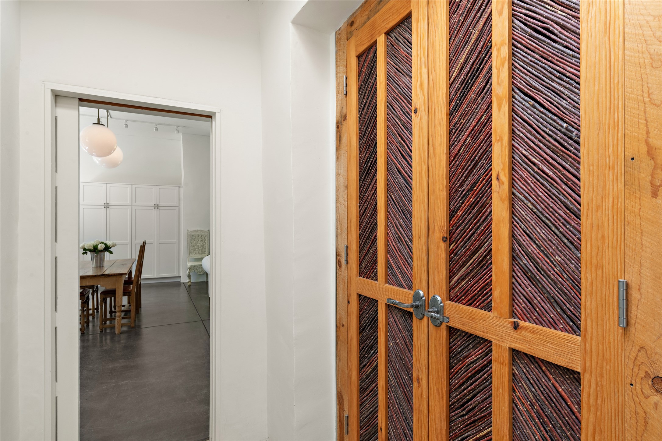 Hand crafted Red willow closet doors in hallway..