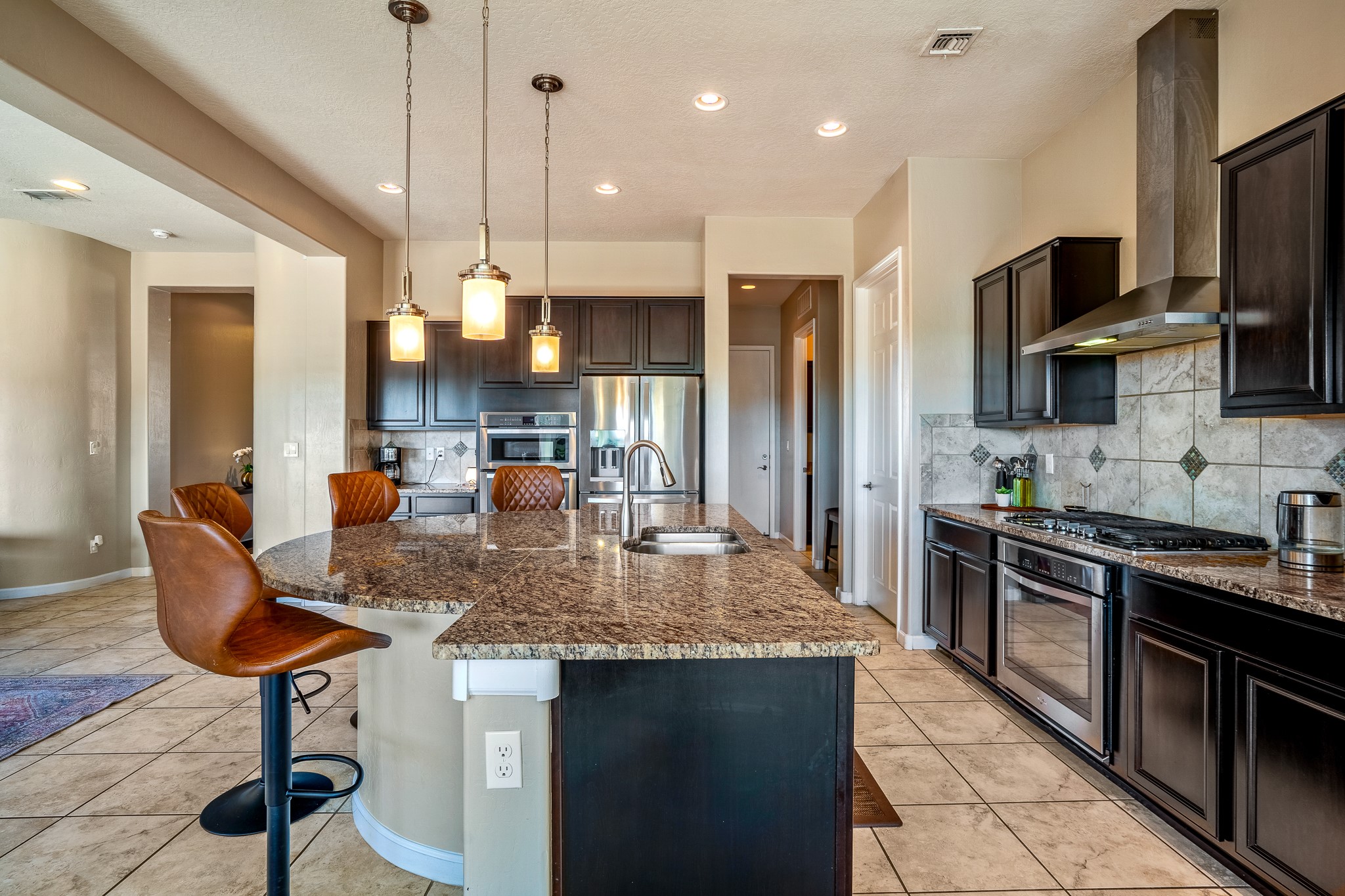 Easy Kitchen Floorplan with pendant lighting, excellent venting and detailed backsplash.