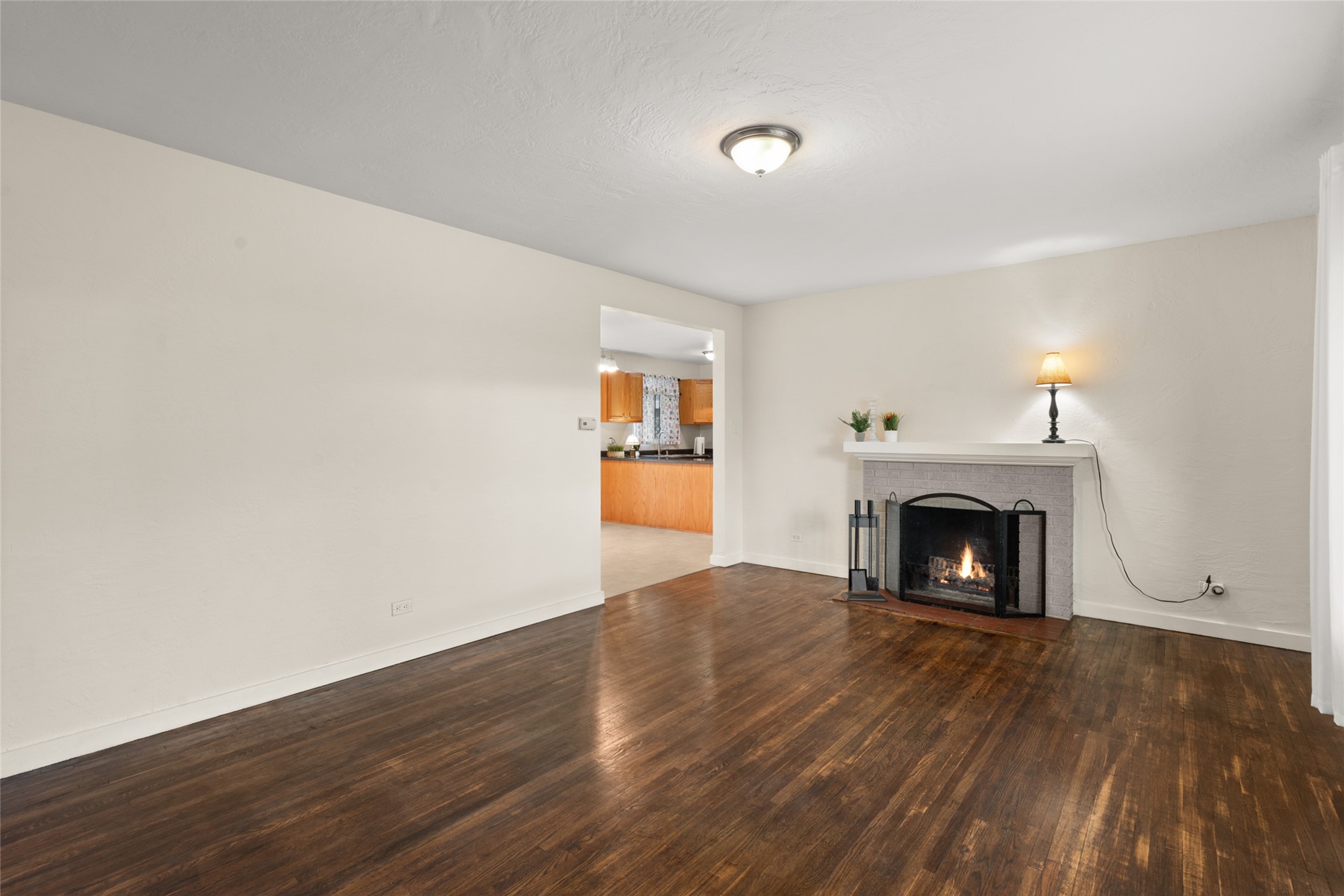 Livingroom with wood floors, looking into dinin groom and Kitchen