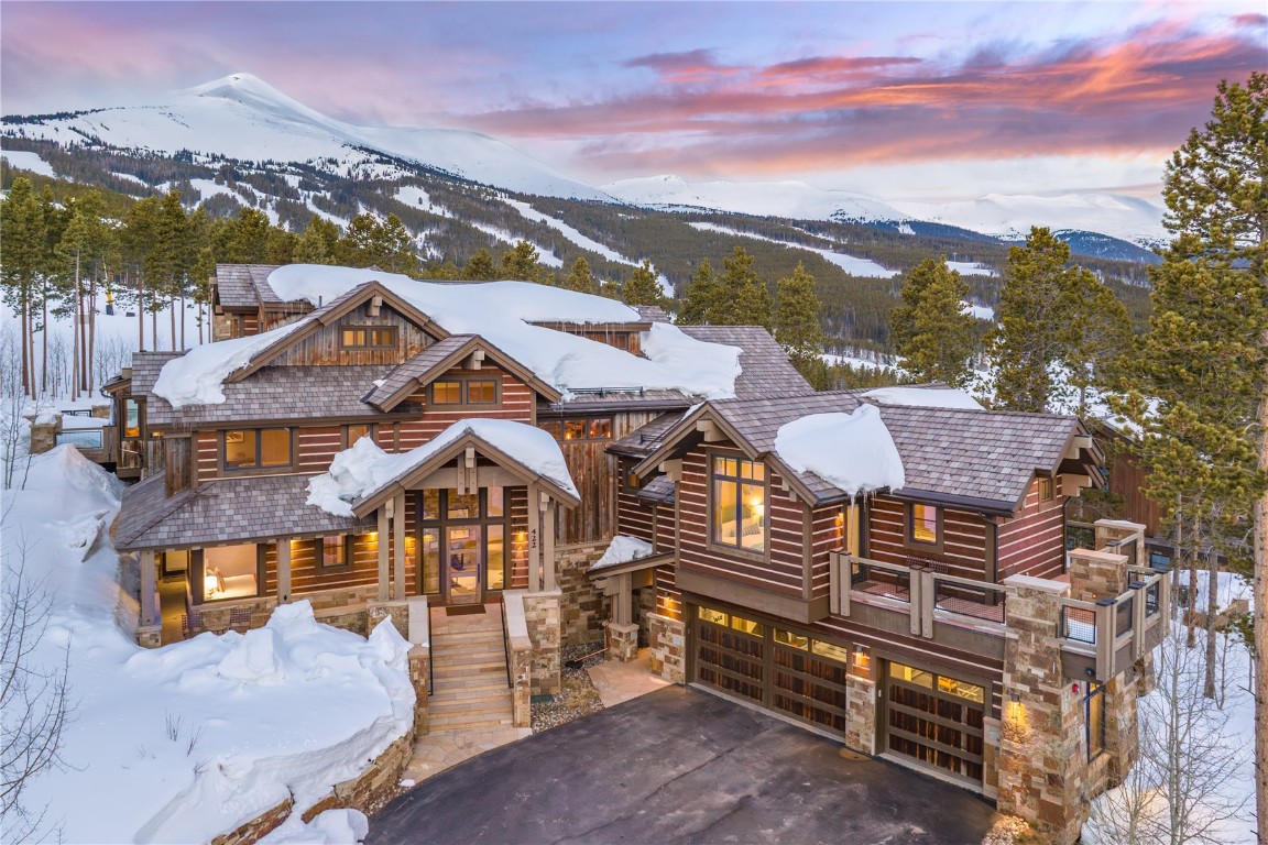 Introducing an unparalleled opportunity to experience the pinnacle of luxury living in Breckenridge, Colorado. Nestled steps from the edge of Trygve’s ski run on Peak 8, this extraordinary property boasts the title of arguably the best ski-in/ski-out lot in the area, offering unparalleled first-chair access to the Breckenridge Ski Resort.

Crafted with meticulous attention to detail, this home's floor plan is tailored to maximize its use, featuring eight bedrooms strategically positioned for comfort and convenience. Indulge in relaxation in the outdoor slope-side 14-person hot tub and an exquisite steam room for luxurious rejuvination after a big day on the slopes. The perfectly located ski locker room, equipped with boot dryers, glove dryers and ample cubbies is unmatched. Outside, multiple living areas beckon for outdoor enjoyment, with a slope-side patio complete with grand gas firepit, that provides an ideal setting for gathering with friends and family under the stars. The gourmet chef's kitchen boasts a massive island to accommodate even the largest of gatherings. The stunning glass elevator offers effortless access to all five floors, allowing you to traverse the home while immersing yourself in its surroundings and intricate details. The expansive game room offers endless entertainment with bubble hockey, pool table, ping-pong, and pinball, complemented by a stylish wet bar. Retreat to the main level primary suite, complete with a cozy den and a fireplace heated deck, offering a tranquil escape amidst the mountain splendor.

The interior design seamlessly blends traditional charm with contemporary flair and industrial accents, featuring barnwood accents and a striking 3-story tall artisan rock wall. From every angle, breathtaking views of the Breckenridge ski area and surrounding landscape captivate the senses. Experience luxury living and investment potential with this remarkable skiers' haven.