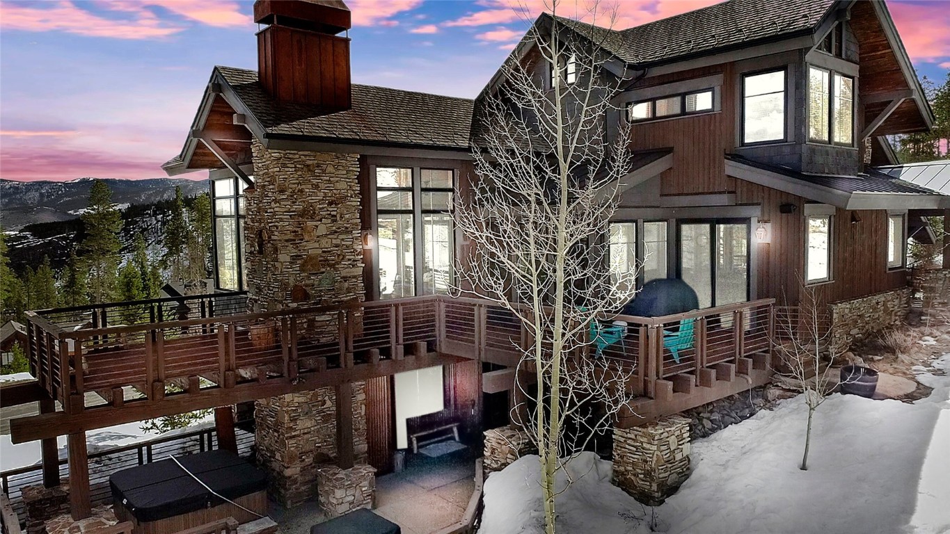 Discover The Highlands of Breckenridge in this exquisite home with breathtaking views of the surrounding peaks. Situated in the heart of Breckenridge, Colorado, this residence offers over 1,000 square feet of outdoor living deck and patio space, perfect for soaking in the crisp mountain air and enjoying the scenic beauty.
As you step inside, you'll be greeted by walls of windows that frame the picturesque landscape, creating a seamless connection between the indoor and outdoor spaces. This home features magnificent stone and beam work, a custom library, and a chef's kitchen. The centerpiece of the living area is a commanding wood-burning fireplace, which pays homage to Breckenridge's rich mining history while providing a warm and inviting ambiance. 
The home comfortably sleeps 12 guests. With four bedrooms and several additional sleeping areas, including a secret bunk nook, there's plenty of room for family and guests to relax and unwind. The master suite is a true sanctuary, featuring a spa-like ensuite bathroom and private access to the outdoor deck.  This home has it all - including solar panels, an outdoor hot tub & firepit, and an oversized two-car garage for all your toys.