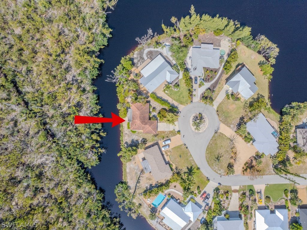 Storm Damaged AS-IS sale on a creek leading to a lake, great for kayaking. Ideal location close to downtown Sanibel, shopping, beach access and bike paths. Easy on & off island location. Pie shaped lot with 140+ feet of creek frontage. Located on a quiet cul-de-sac street.