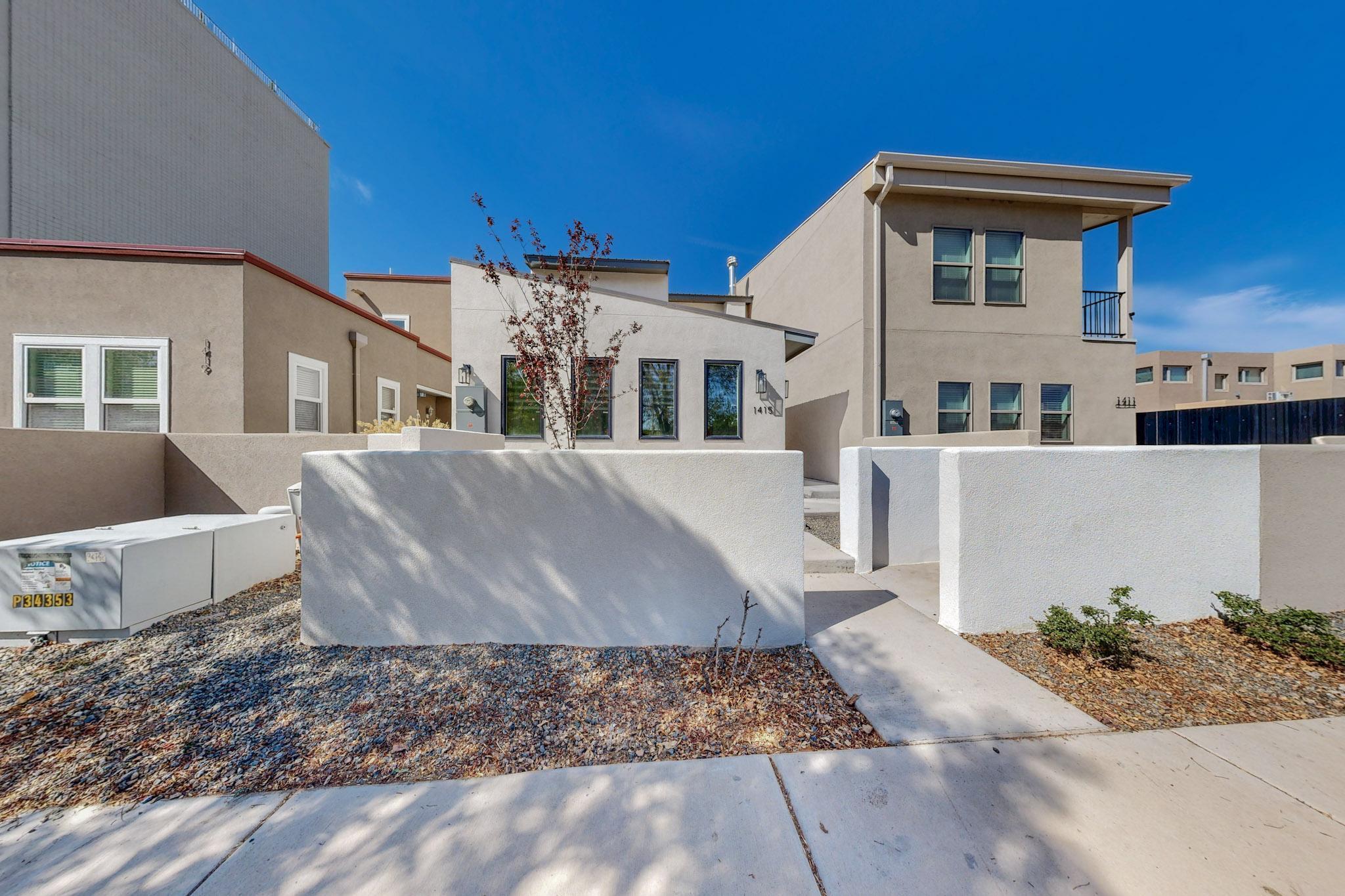 Impeccably crafted, this newly completed luxury townhome, enriched by builder occupancy, boasts a coveted Casita Currently bringing in $2,300 mo. as Vacation rental and always booked. Nestled in the prestigious Huning/Albuquerque Country Club Neighborhood, it provides unparalleled access to ACC, Tingley Beach, ABQ BioPark, and the vibrant tapestry of dining, cafes, shopping, downtown businesses, and government buildings. The versatile zoning permits a seamless live-work integration, allowing for an office, salon, studio, or an additional bedroom at the front with a private entrance and bath--an embodiment of both sophistication and practicality.  Get your showing scheduled!