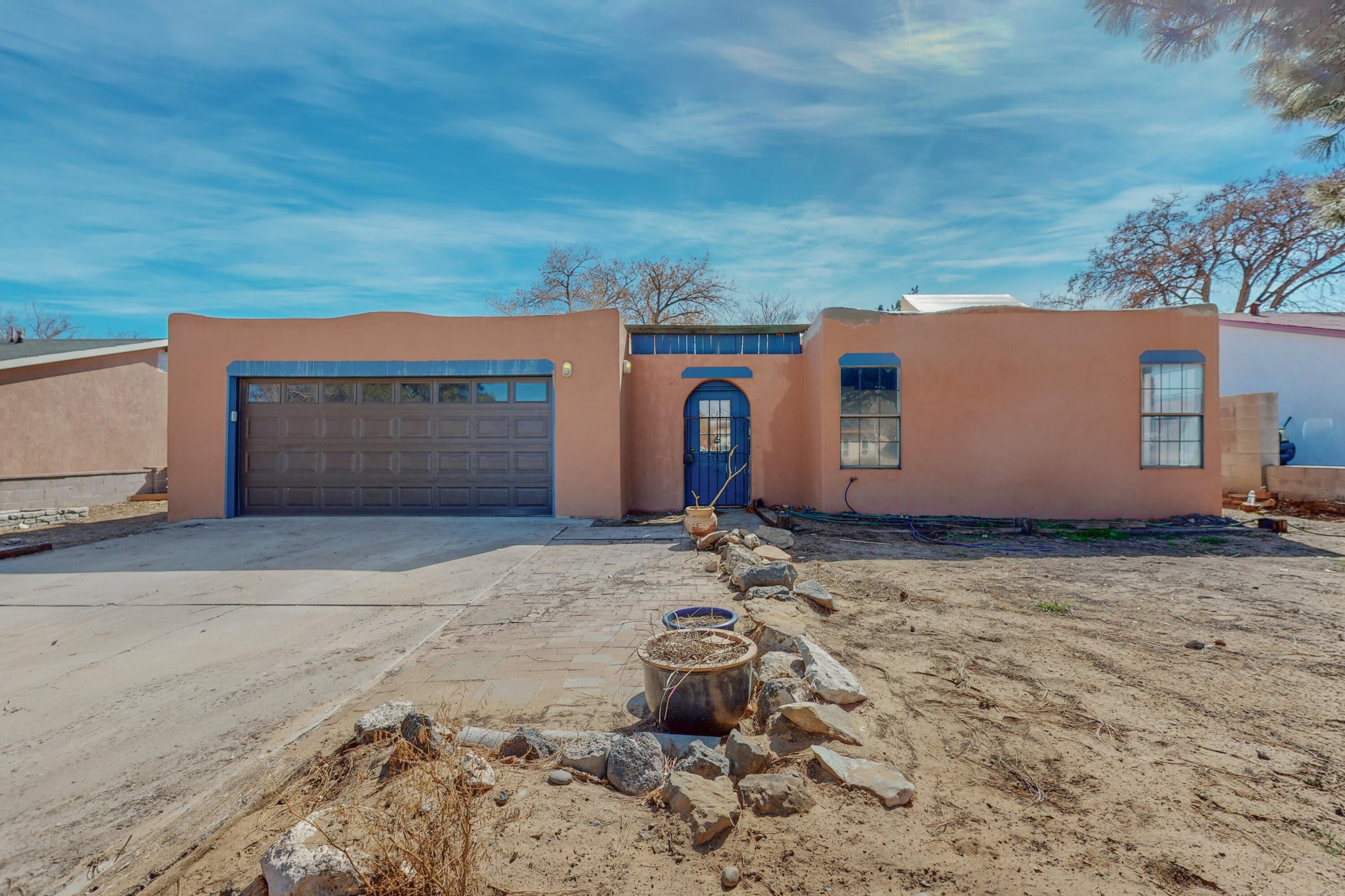 This home is a gorgeous. SELLER IS PUTTINGG IN NEW COUNTER TOPS FOR THE KITCHEN-This home is huge- a large home with room to grow. It features a 6 bedroom/3 bath home, office, front room, family room, country kitchen, and a pond. New paint inside and flooring. There are beautiful vigas and a kiva fireplace. Large backyard- very spacious home. The primary bedroom and bath are upstairs. This home is bursting with sunshine, lots of light. This has so many wonderful touches, come see.- Owner/broker