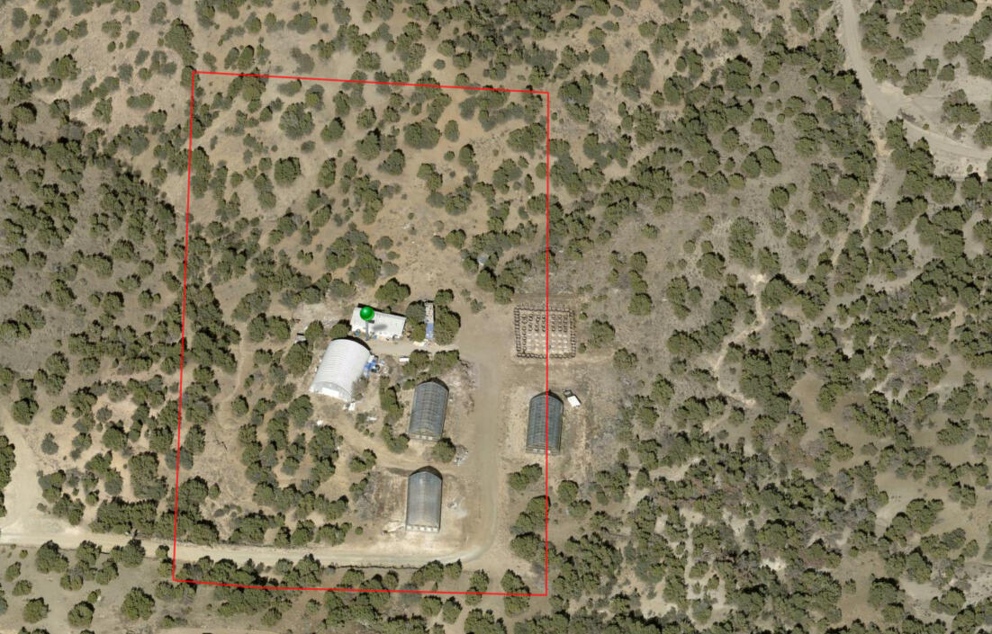 10 acres of private land nestled in the breathtaking Manzano mountains! 2 adjacent plots included (5 acres ea.) with 360 degrees of unobstructed views. Property has 3 newer greenhouses (5400 sqft total), 1 quonset hut metal building (2400 sqft), and a 1bdrm/1bath home (~725 sqft) with living room, kitchen & a sunroom/patio. 420' private well on site.  Endless possibilities, so much room for expansion and development. Property was formerly operating as a Vertically Integrated Cannabis Establishment (VICE) licensed & approved for cannabis cultivation through the NMDOH/NMRLD.