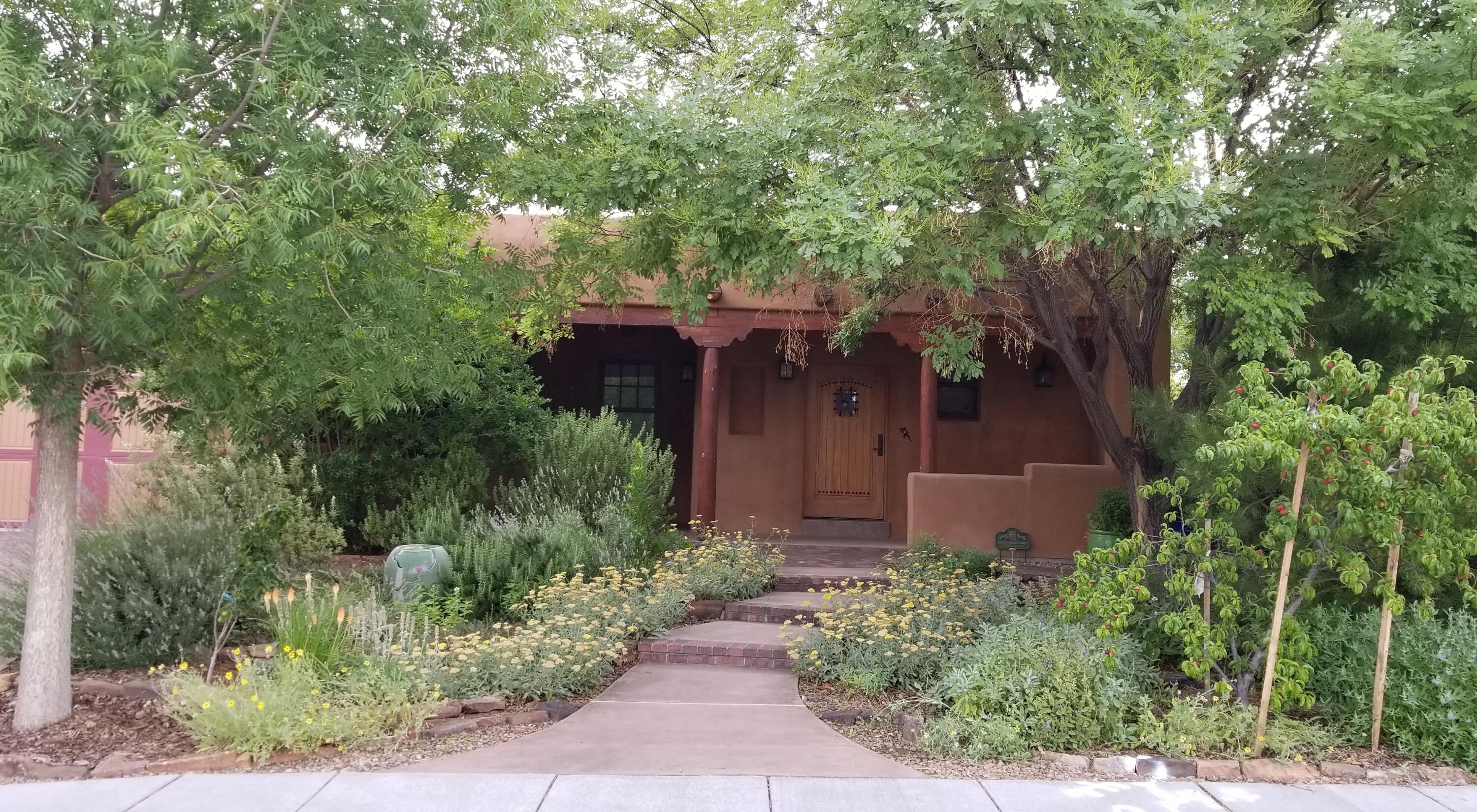 Altura-adjacent Ridge Park! An amazing Pueblo-style home! Renovated top-to-bottom side-to-side & front-to-back in 2010. Now a model of energy efficiency & a showplace of style & taste. It may be one of the best-engineered homes in the area. Updates, upgrades & amenities incl solid oak floors, plaster walls, T&G ceilings, thermal windows, vigas, latillas, corbels, elec service & plumbing + newer TPO roof & stucco. Three bedrooms + ofc incls ''attached casita'' w/bed & bath & separate outside entrance. Incredible open-concept kitchen w/huge pantry. Beautifully landscaped front & back + work shed w/elec svc, wood sauna, rain catchment system, dog clean-up area & 2-car tandem garage. Popular mid-city location puts you within easy reach of Altura Park, Nob Hill, UNM & both Uptown & Downtown.