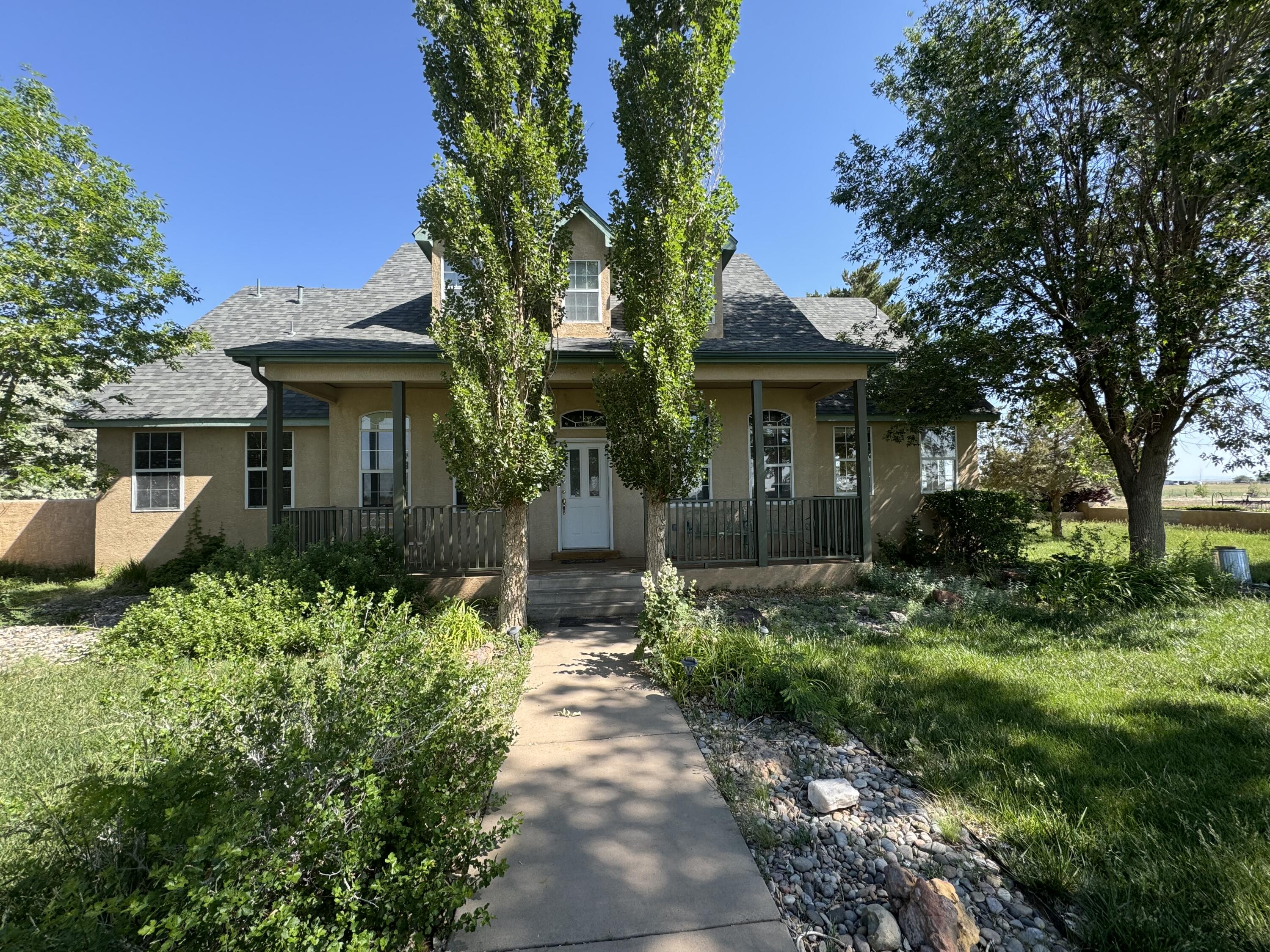 Welcome to this charming home with a classic pitched roof and breathtaking mountain views, perfectly situated on ten acres of serene countryside. A lovely front porch invites you inside, where a warm and welcoming sitting room sets the tone. The open kitchen, complete with a cozy breakfast nook, flows seamlessly into a spacious living room featuring a beautiful fireplace--perfect for gathering and relaxation.The primary suite offers a peaceful retreat on the main level, accompanied by a second bedroom that can easily serve as a study. A versatile flex space, along with two additional bedrooms and a full bath, provides ample room for family and guests. Step outside to the covered patio, where you can take in stunning vistas of the mountains and rolling pastures.