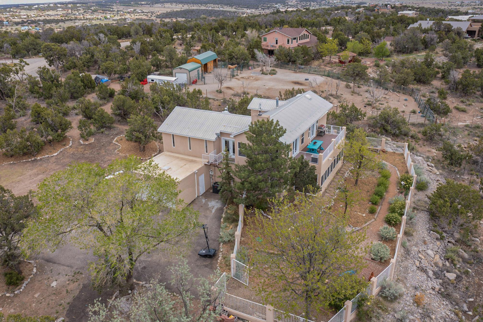 Welcome home to your own slice of New Mexico paradise! Sitting up high in thunder mountain, you can take in the gorgeous views that surround from the upper living area and balcony. This home has many recent updates making it turn key for the new owner. With 4 bedrooms, 3 baths, huge garage, and 1.78 acres, there's plenty of room for everyone. Easy commute to Albuquerque or Santa Fe. Schedule your showing today before it's gone! Virtual tour available.