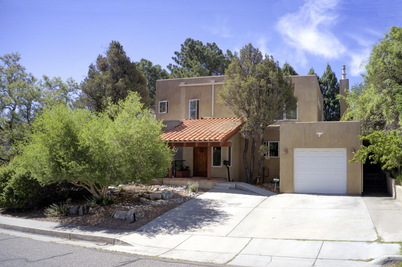 Stunning Spacious UNM Area home with incredible mountain views. Major remodel in 2005 including 1213 SQ FT upstairs addition. Gorgeous hardwood floors throughout except in brick Foyer,2 bedrms + the stairway. All carpet new in 2024. Wooden metal-clad casement windows. 5 roomy bedrooms plus a family room with a sink, built-in counter & cabinets plus a 2nd washer and dryer.  Huge master suite with 220 SQ FT master bath with separate tub & shower, water closet and 2 walk-in closets. East facing balcony off FR and Master Bedrm. Private east facing patio off LR. Hot water baseboard heat. 2 refrigerated air units.  New top of the line reverse Osmosis system for all drinking faucets in 2023.  New TPO roof with warranty in 2019. Freshly painted. 2nd upper bedrm is ideal home office. Price Reduced