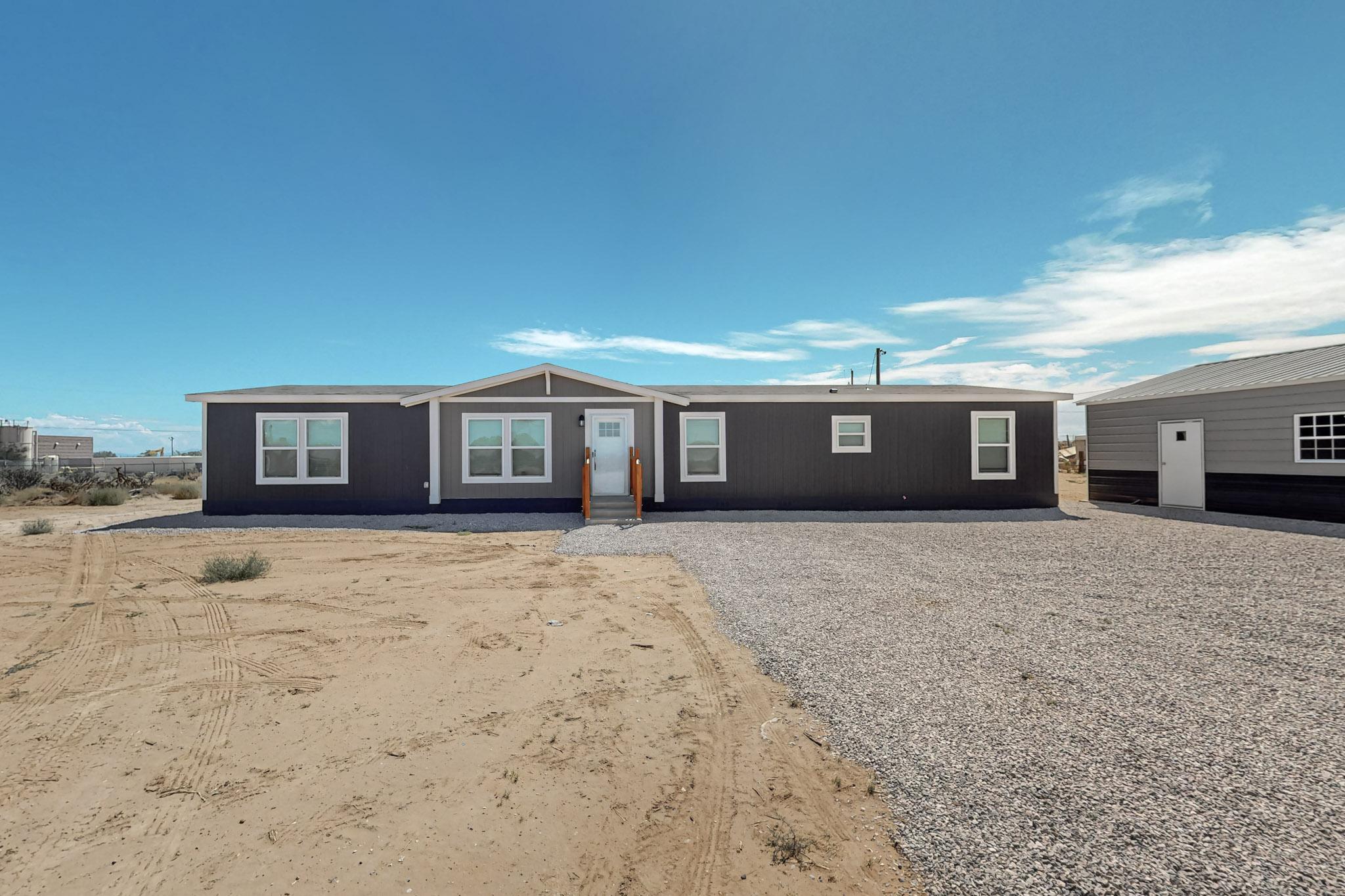 This Brand New Clayton Home is close to shopping at Unser and Southern but still sits in the peace and quietness of the county. Home is in Rio Rancho School District and Comes with the Furniture and Decor. The is on a Permanent Foundation that qualifies for VA, FHA,Conventional, and USDA Loans. Home sits on One Acre of Land. Home comes with four bedrooms, two bath, an open concept living room, dining room, large kitchen with a large center island, second living room, plus flex area. Some of the other features Stainless Steel Appliances, Ecobee Smart Thermostat that you can operate remotely on your phone with app, Refrigerated Air. Spacious owners suite with luxury bathroom that has a long soaking tub and walk in shower.