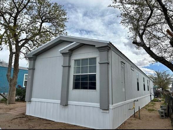 Spacious 3 bdrm 2 bath manufactured home for sale that boasts a new metal roof, new skirting and fresh exterior paint. Interior has modern design colors and upgraded kitchen cabinets. This home is in the popular Van Cleave gated community. Van Cleave Mobile Home Park is known for its privacy, cleanliness and community, family friendly park.   Its located close to Kirtland Air Force Base, shopping and the freeway. Home includes Kitchen stainless steel appliances  and washer and dryer! Space Rent  is $580 BUT that includes water, sewer and trash! BONUS(Seller will pay $100 off your space rent for 6 months!