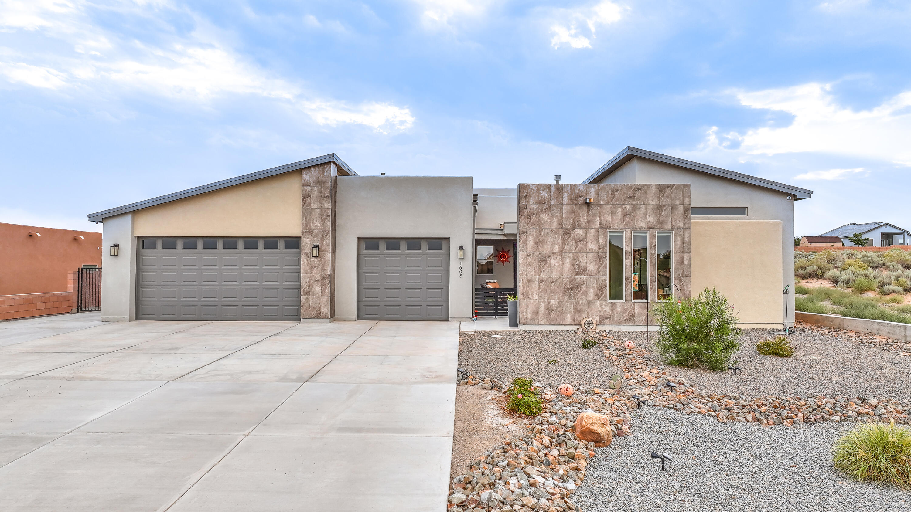 $25,000 total PRICE IMPROVEMENT! Motivated Seller, ready to move and make this amazing home YOURS! Step into this beautiful, modern, 2-year-old home on a fully landscaped 1/2 acre lot in the growing area of Rio Rancho next to Westside Blvd. IN- LAW SUITE with sitting area and mountain VIEWS, kitchenette, full bathroom with double sinks, walk in shower and large bedroom. The home boasts many upgrades including quartz countertops throughout, large windows to view the amazing NM sunsets, and a separate office off of the kitchen.  The large back yard has been fully landscaped and includes side yard access with concrete and a gate to fit your vehicle or camper, grass, flower beds, a pergola, lighting, and a huge 25