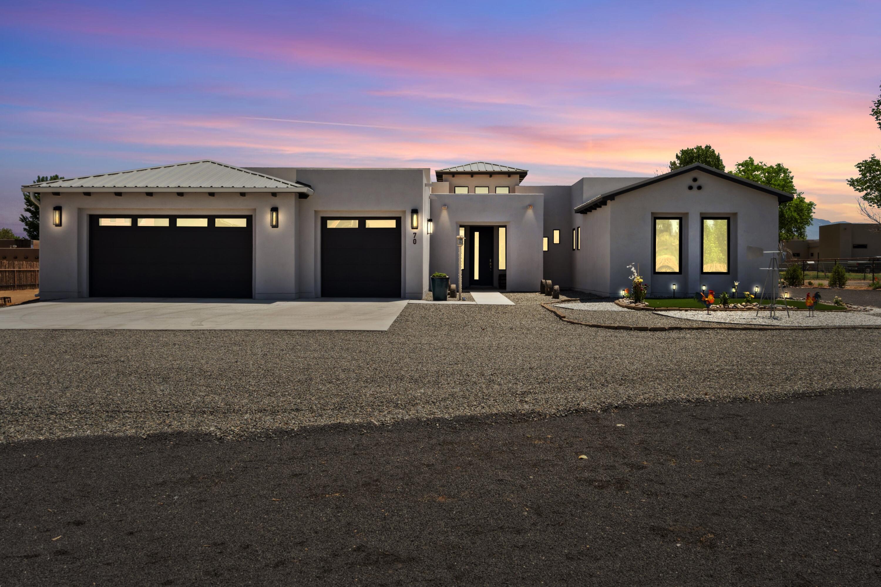 Step inside your dream home! This newly built single level luxury property sits on a sprawling 1-acre lot in Corrales, offering unparalleled elegance & comfort. As you step inside, you'll be captivated by the exquisite design & high-end finishes throughout. The open floor plan seamlessly connects the living spaces, showcasing a high-end kitchen perfect for the culinary enthusiasts. The primary suite boasts walk-in closets & a resort-style bathroom, providing a private retreat of luxury & relaxation. Exterior highlights include an expansive rooftop deck, with fully landscaped rear courtyard, perfect for entertaining or enjoying serene sunsets with panoramic mountain views. The meticulously landscaped grounds feature an orchard of fruit trees, providing both beauty and a bountiful harvest.