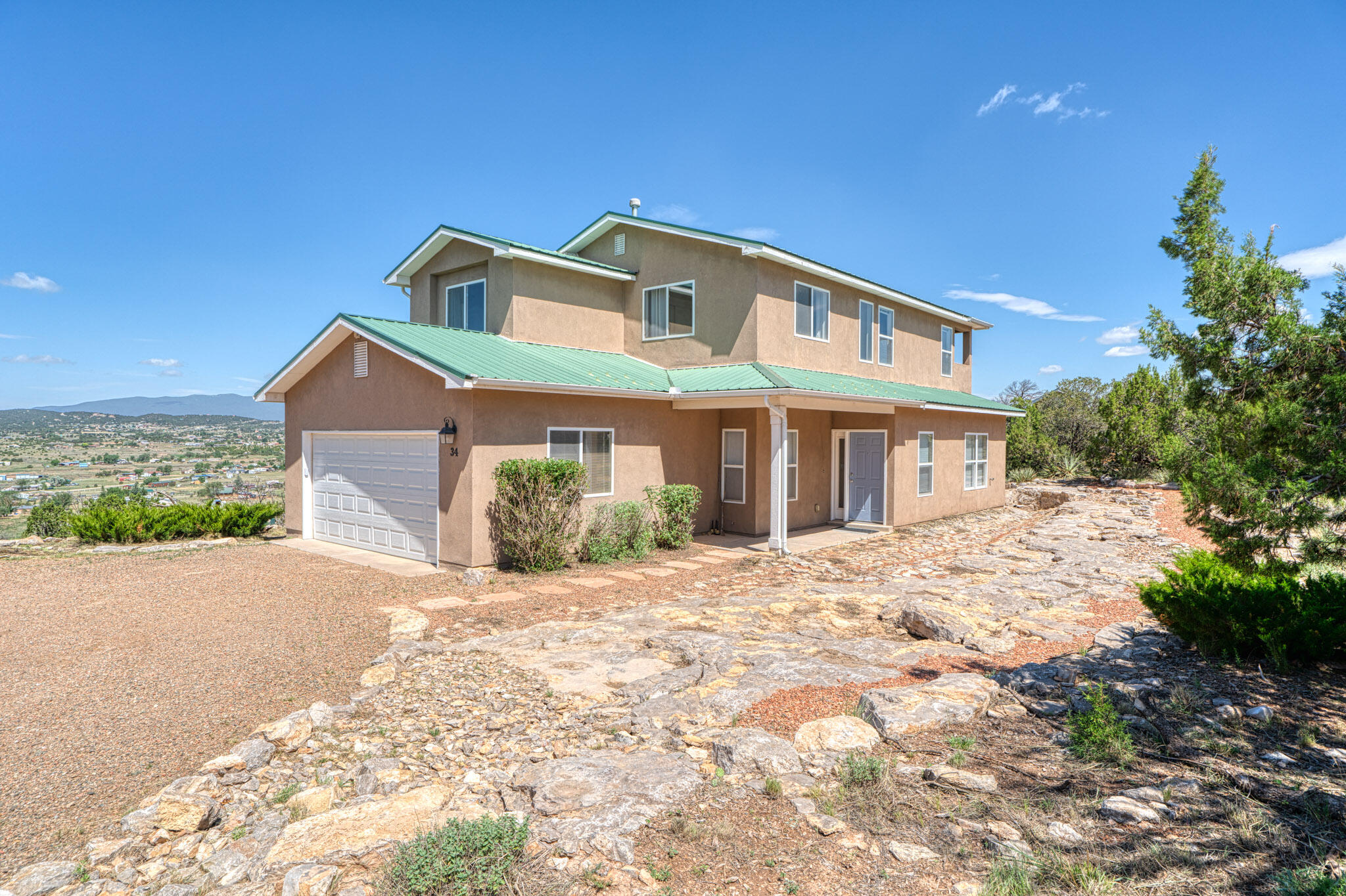 Enjoy breathtaking views and stunning sunsets from this peaceful rural home just 30 minutes from Albuquerque and oh so close to Edgewood shopping. Set on a xeriscaped lot with native, low-maintenance plants, it offers privacy between neighbors and room to roam. The spacious layout includes a main-level bedroom with a 3/4 bath, 3 more upstairs bedrooms including a primary suite with a private balcony, ample storage, and a large detached workshop--perfect for hobbies or projects. A full home generator adds peace of mind. Want more space? The adjoining 2.5-acre lot is also available for sale. Move-in ready and waiting for the right buyer - this home won't disappoint!