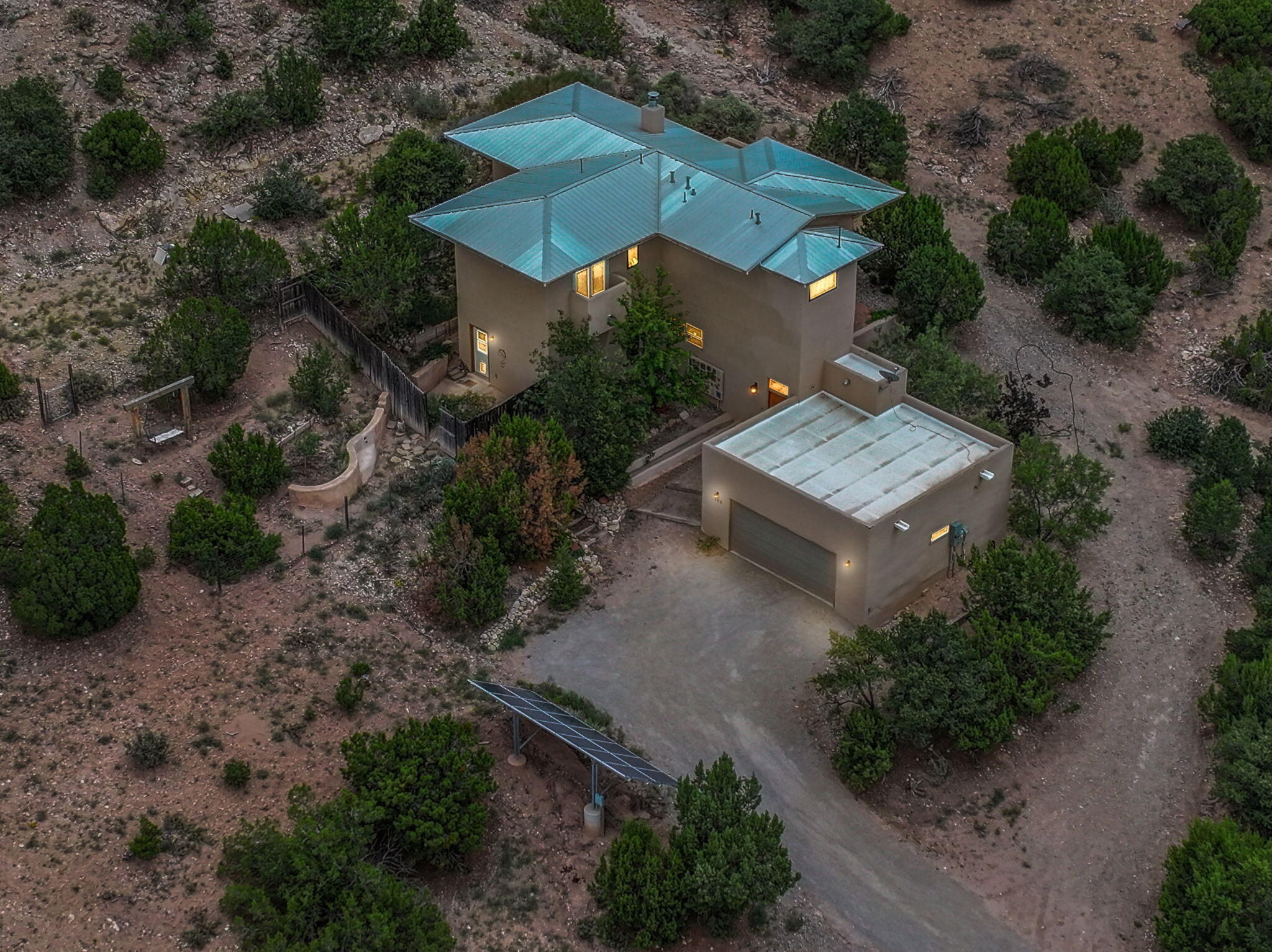 Custom home in Placitas on 5.64 acres made with sustainable materials enbedded in the beautiful craftmanship of the home. The home runs on solar panels, is built with Apex 10'' block & SIP. Incredible views from almost every window.  Beautiful kitchen with stainless steel appliances, custom hickory cabinets, stained concrete floors and bamboo. Three bedroom and three bathroom plus office or studio/office/artist space and 2178 sq ft. Wood burning fireplace & solar chimney keeps warm in winter. Travertine tile, wet bar upstairs, fruit trees, rain catches, wild horses outdoors, many outdoor patios, two car garage, makes this home a unique and gorgeous gem.