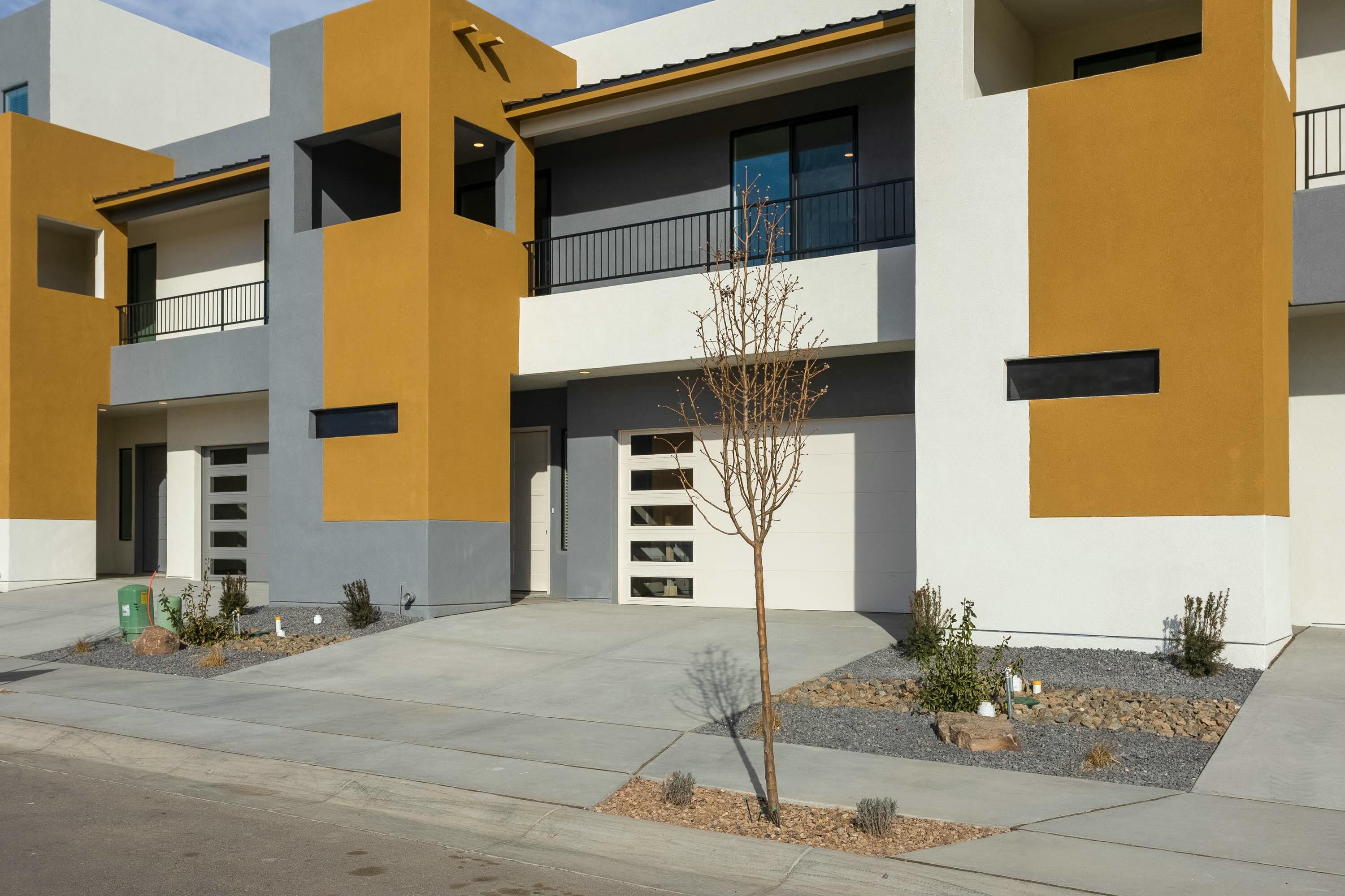 Luxury living at its finest! New townhome project in the heart of the NE Heights is just what you've been waiting for-luxury living in the heart of Abq. The Tate is a spacious 2-story with all bedrooms up and a balcony on the 2nd floor. Covered patio and 10' ceilings on level 1. Owner suite has walk-in closet, separate tub and shower and dual vanities. Full appliance pkg includes gas cooktop, oven/micro, DW, SxS refrigerator. Lg sliding doors open to covered patio. 8' tall garage door with opener for your larger vehicles, built in Taexx pest control system. Front yard is landscaped and irrigated. 2-10 Ltd Home Warranty AND exclusive 1-yr Builder Warranty. Head out today and visit our beautifully furnished model home before this gated community sells out.